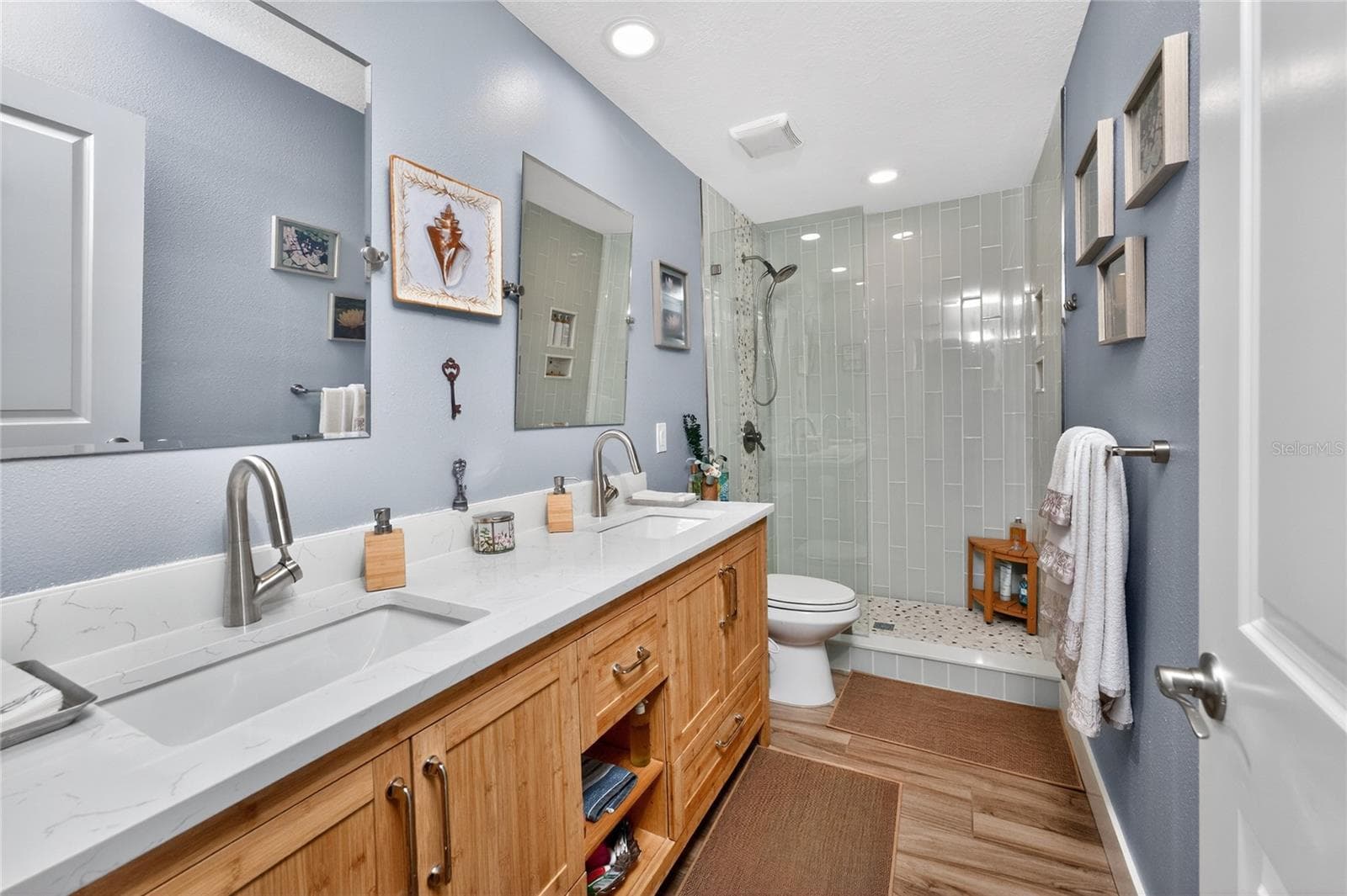 This redesigned second bathroom pairs contemporary style with everyday luxury - Bamboo Vanity with Quartz Counters - 80 SABAL DR, PUNTA GORDA
