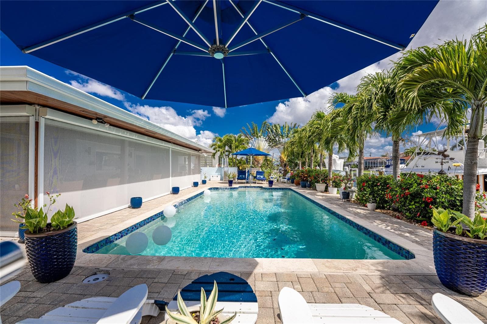 Designed for easy living, the home's impact glass windows and sliders, Bahama shutters, and Kevlar storm screens bring lasting peace of mind through every season. - 80 SABAL DR, PUNTA GORDA