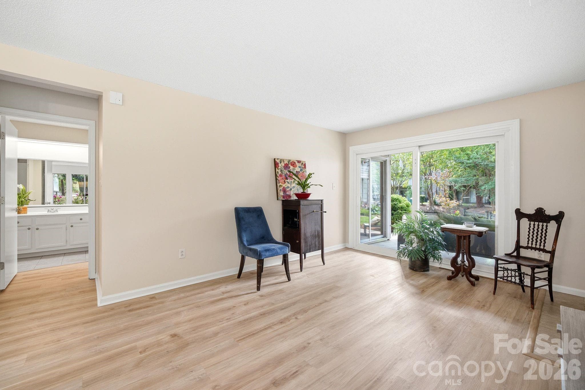 Living room area and view to back porch area that looks over the pond and natural areas - Charlotte