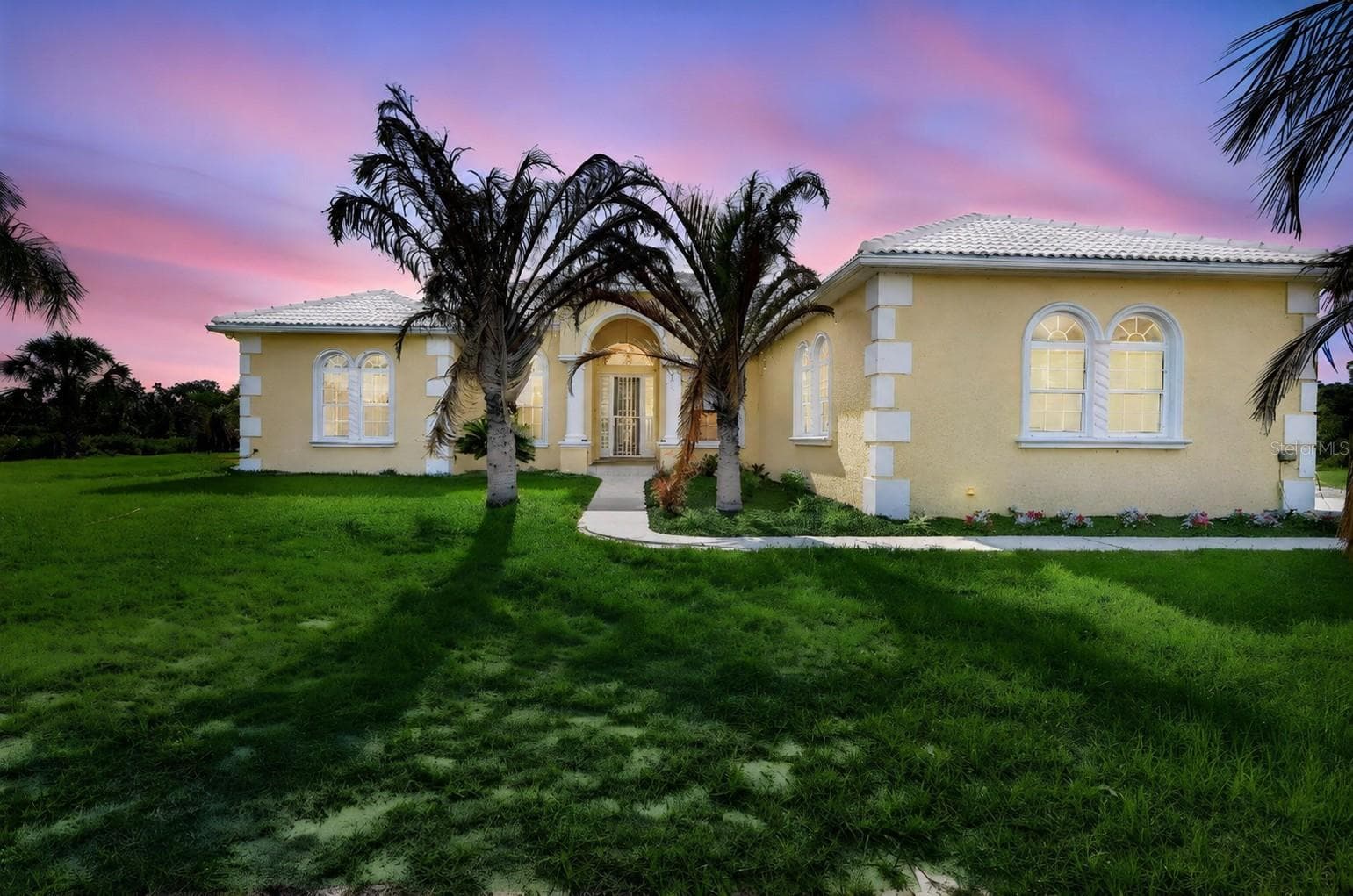 Stunning curb appeal highlighted by elegant architectural details, mature landscaping, and the timeless craftsmanship of this custom-built estate home. - 1210 408TH CT E, MYAKKA CITY