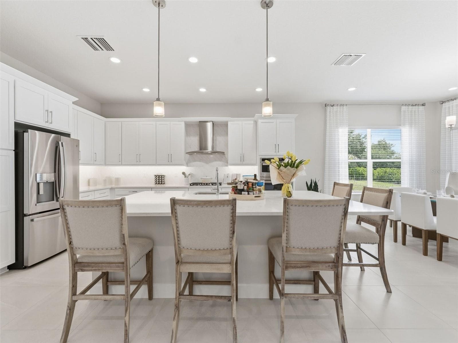 This kitchen features an oversized island with casual seating. - 3857 CABERNET TER, WESLEY CHAPEL