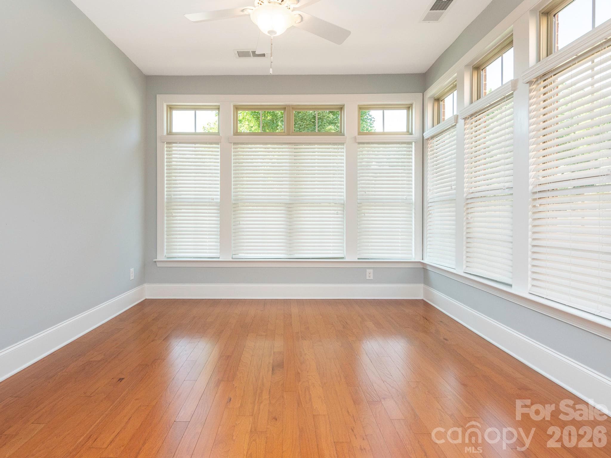 Inviting sunroom with abundant natural light and ceiling fan. - 4534 Ideal Way, Harrisburg