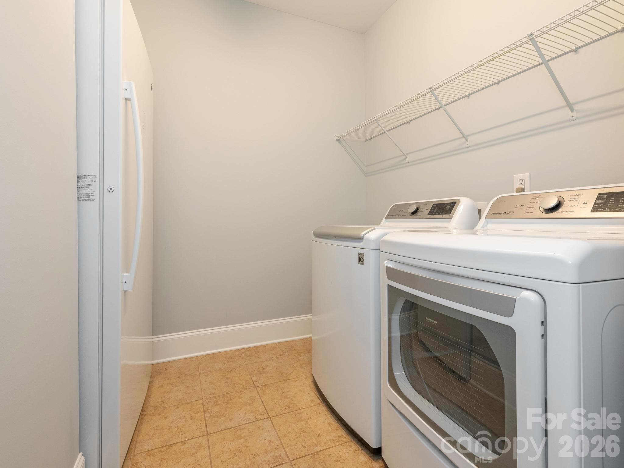 Large laundry room has shelving and a storage closet where the water heater is located. - 4534 Ideal Way, Harrisburg