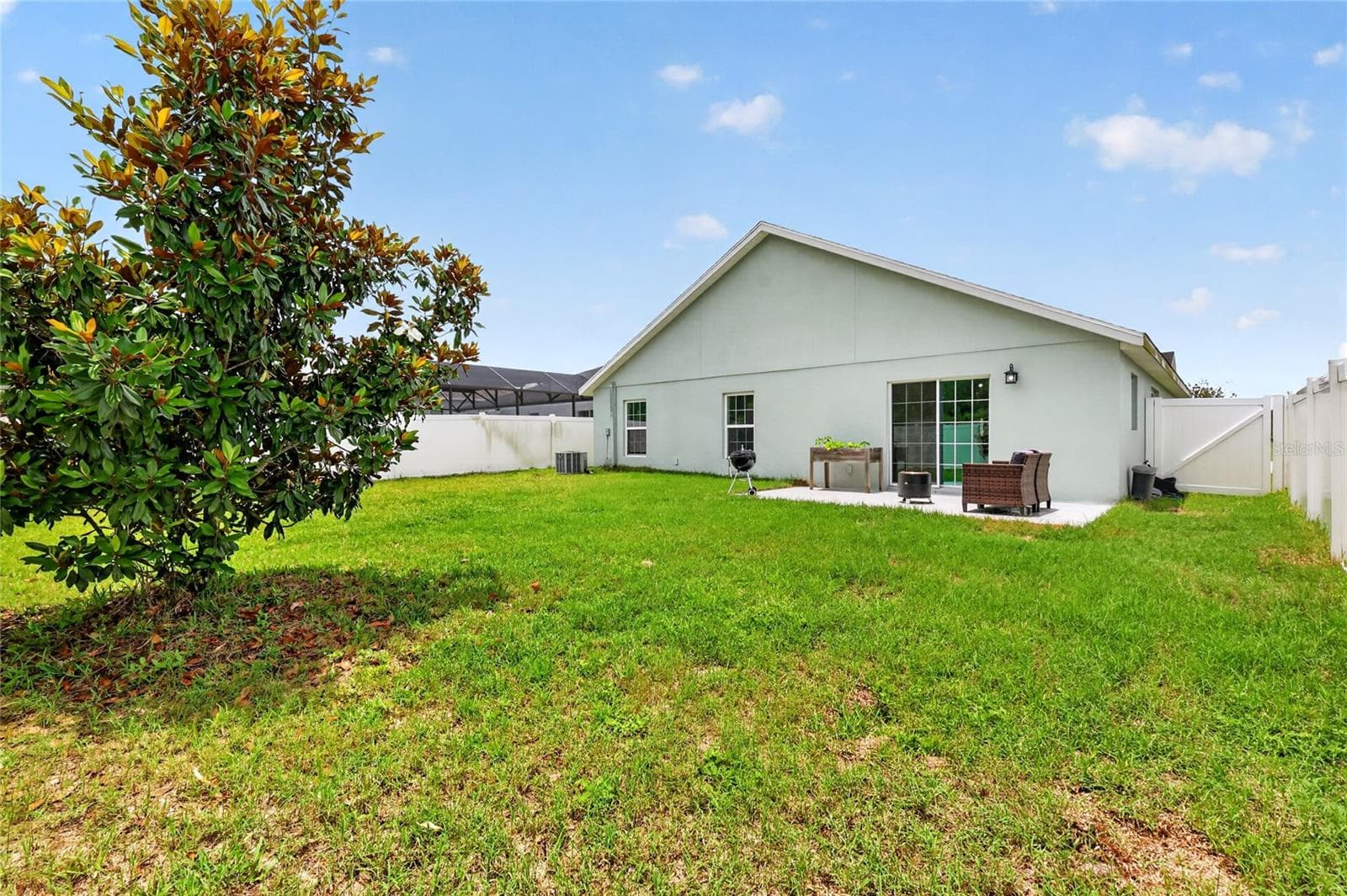 Rear Elevation with Patio, Large Fenced Yard, and Room For a Pool! - 12591 NE 49TH DR, OXFORD