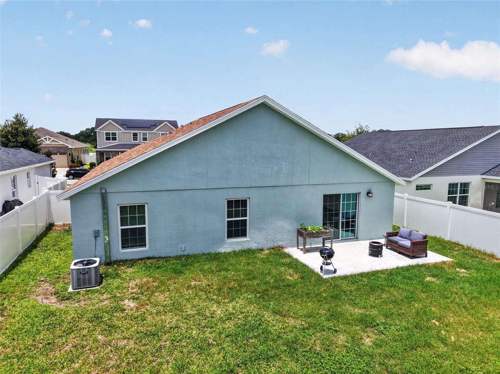 Rear Elevation with Patio, Large Fenced Yard, and Room For a Pool! - 12591 NE 49TH DR, OXFORD