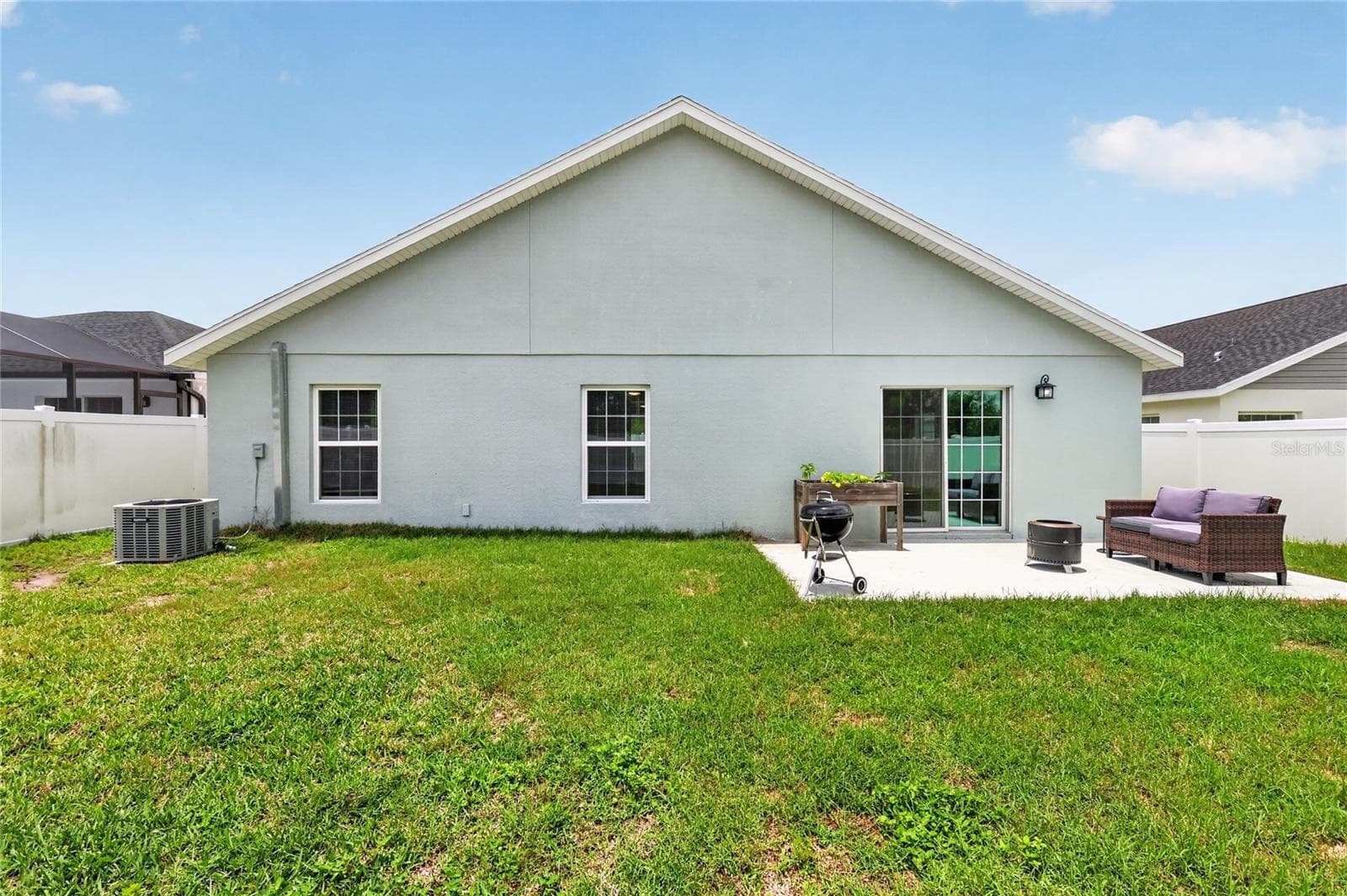 Rear Elevation with Patio, Large Fenced Yard, and Room For a Pool! - 12591 NE 49TH DR, OXFORD