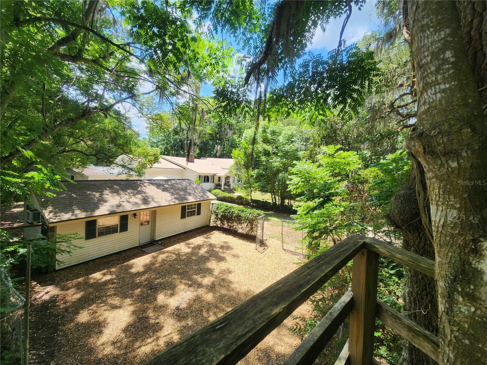 View of guest house and main house in the background from the tree house - 1985 NE 97TH STREED RD, ANTHONY