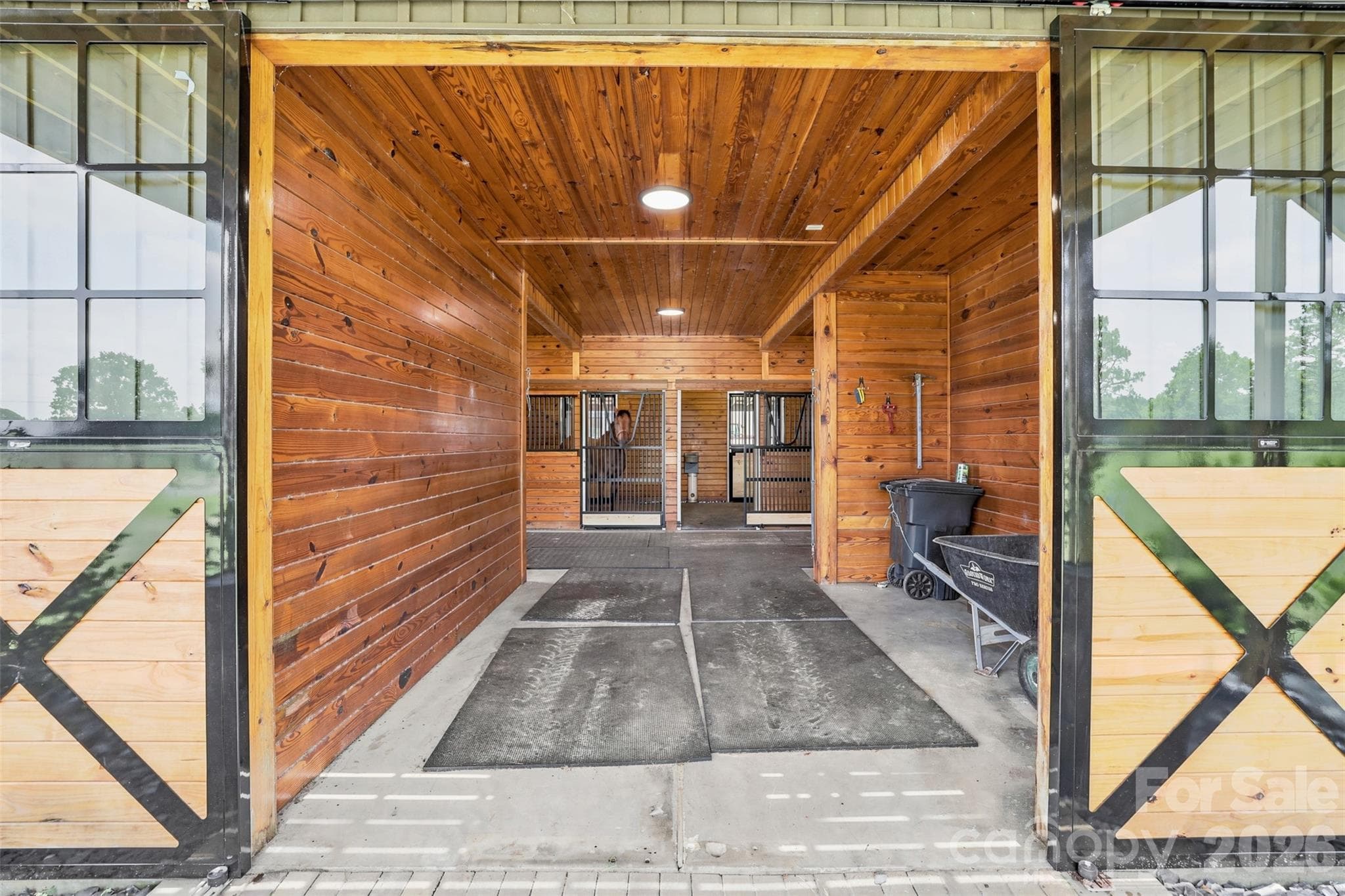 Thoughtfully designed barn exterior offers easy access to paddocks, pastures, and equestrian amenities. - 8520 Stock Horse Trail, Windsor