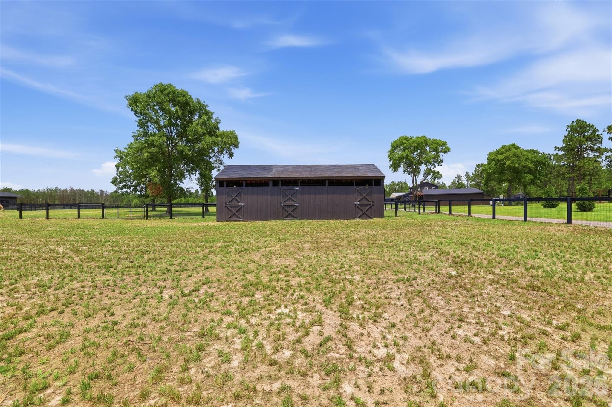 Open pasture views showcase the property's acreage and horse-friendly layout. - 8520 Stock Horse Trail, Windsor