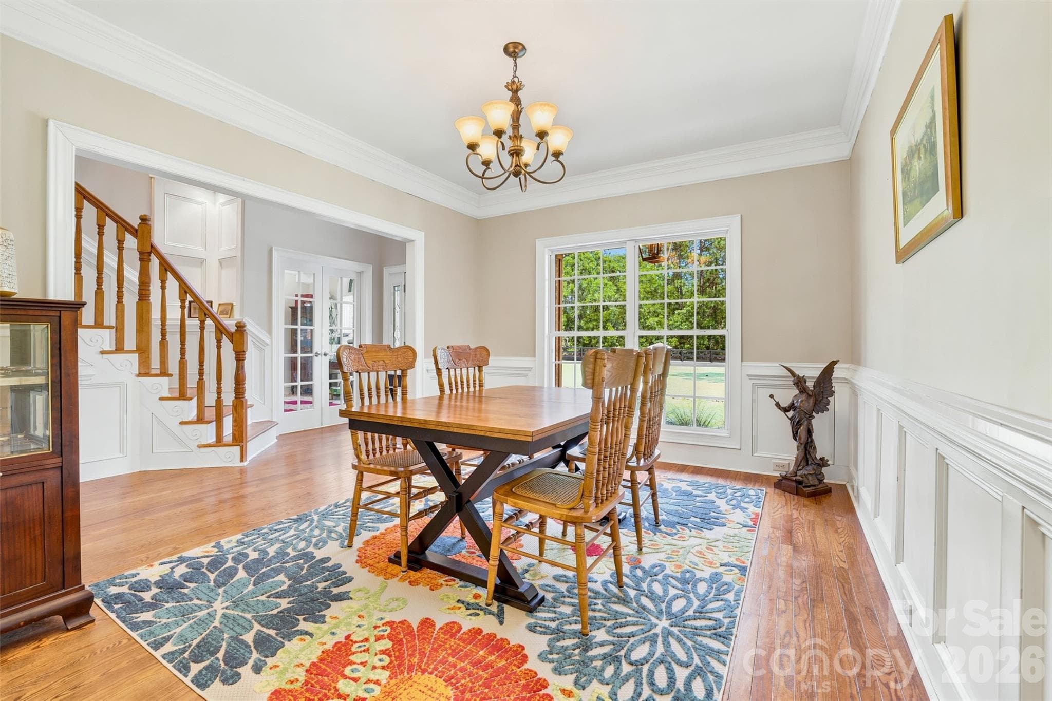 Grand foyer showcases hardwood floors, soaring ceilings, and a striking staircase. - 8520 Stock Horse Trail, Windsor
