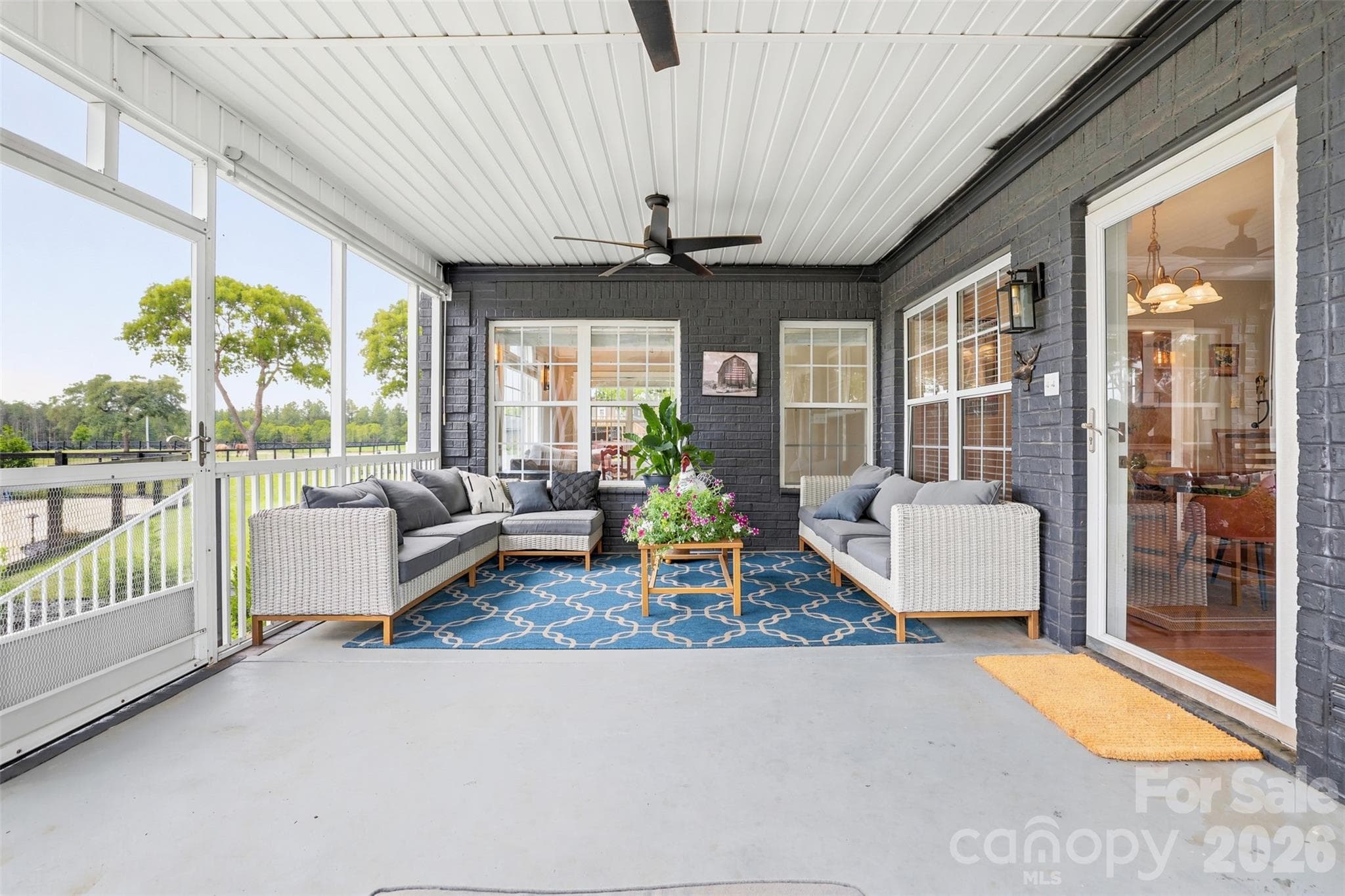 Bright and inviting sunroom offers panoramic views of the property and year-round enjoyment. - 8520 Stock Horse Trail, Windsor
