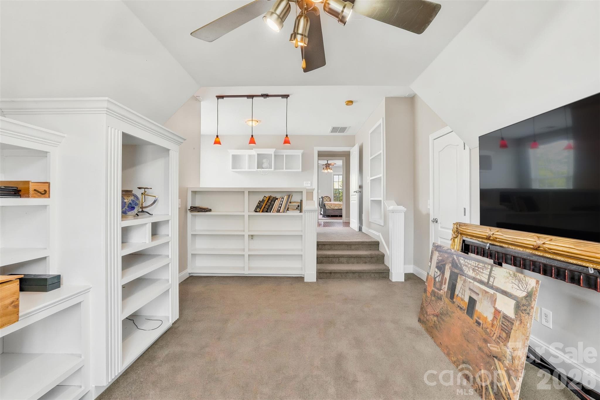 Grand foyer showcases hardwood floors, soaring ceilings, and a striking staircase. - 8520 Stock Horse Trail, Windsor