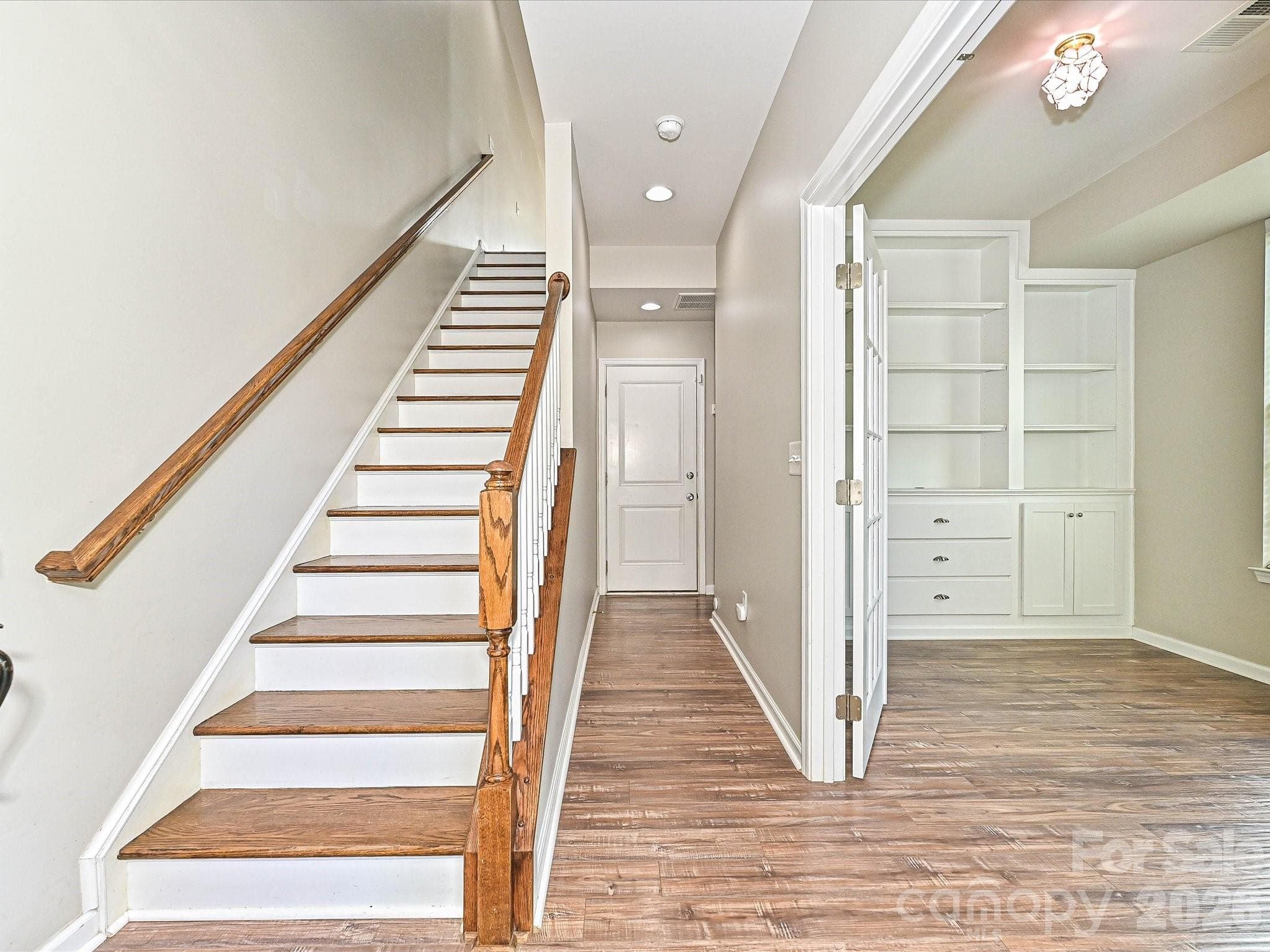 LVP Flooring and Wood Staircase; Study with Built in Cabinets - Cornelius