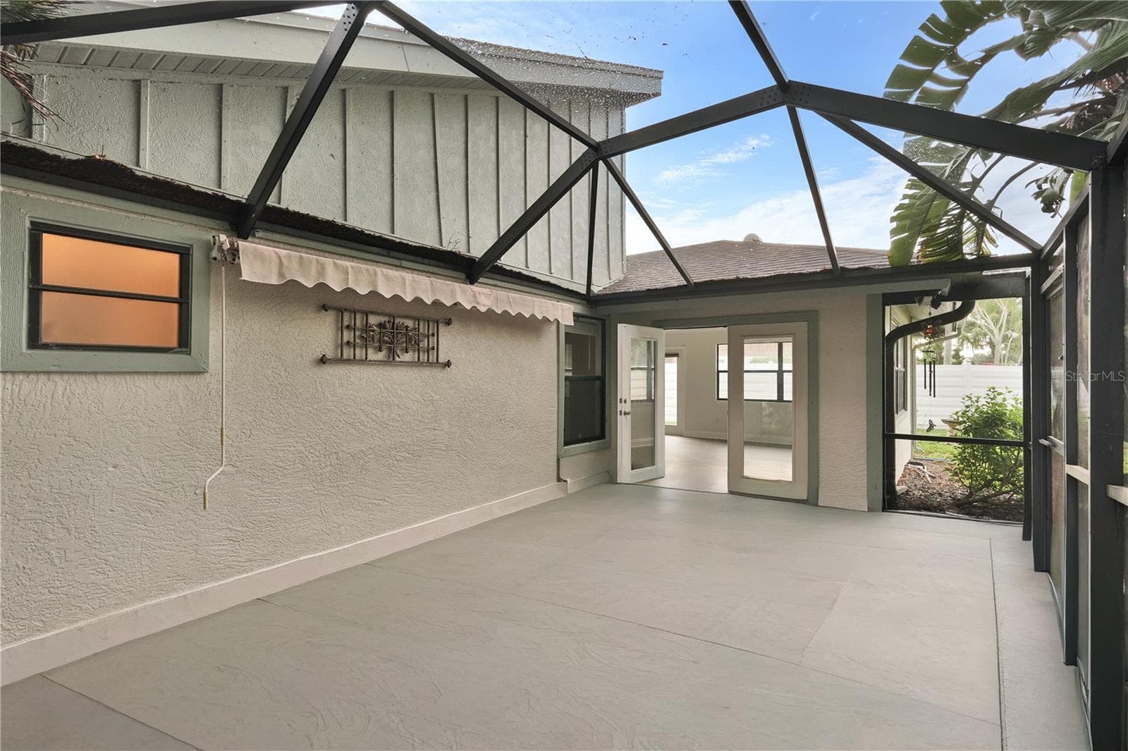 Screened patio adjacent to Florida room - 7861 PINE TRACE DR #7861, SARASOTA