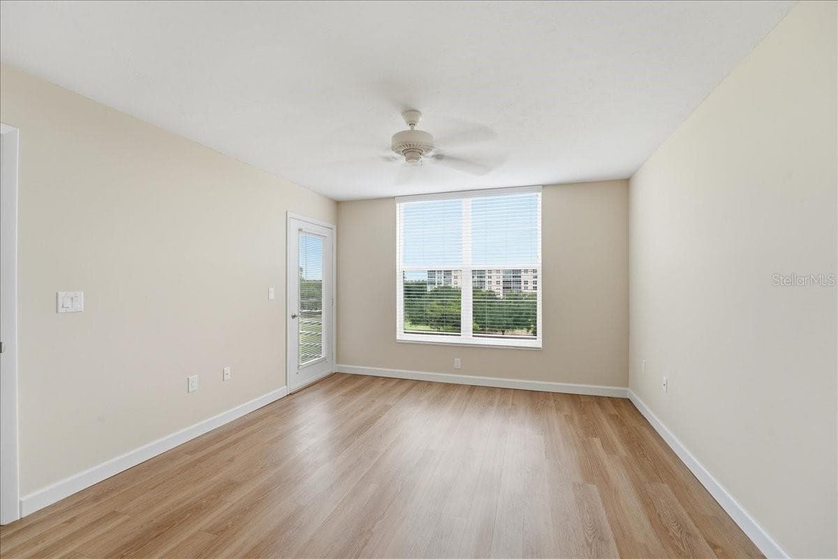 Primary bedroom with door to the lanai - 4550 PINEBROOK CIR #506, BRADENTON