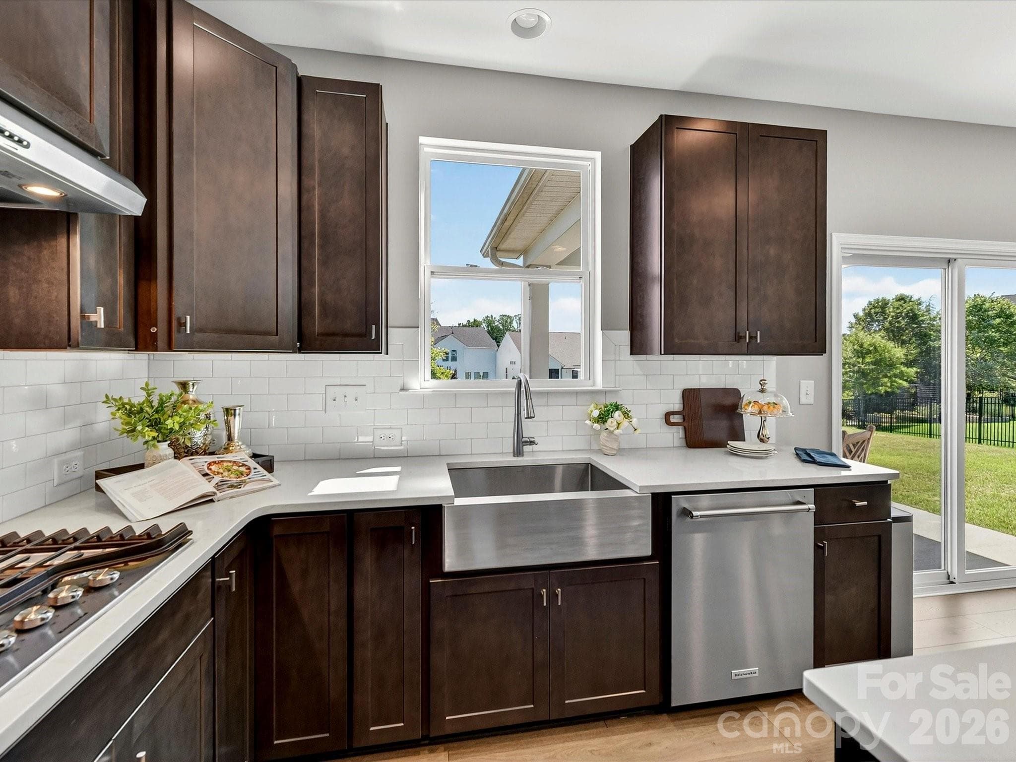 stainless Farmhouse Sink, Quartz Counters, Tiled Backsplash, Gas Range, Vented hood - 6203 Six String Court, Fort Mill