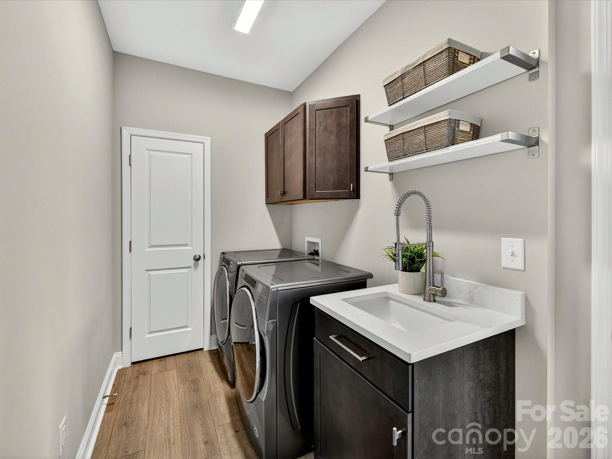 Laundry Room with Closet, Utility Sink, Shelving and Washer Dryer to Remain - 6203 Six String Court, Fort Mill
