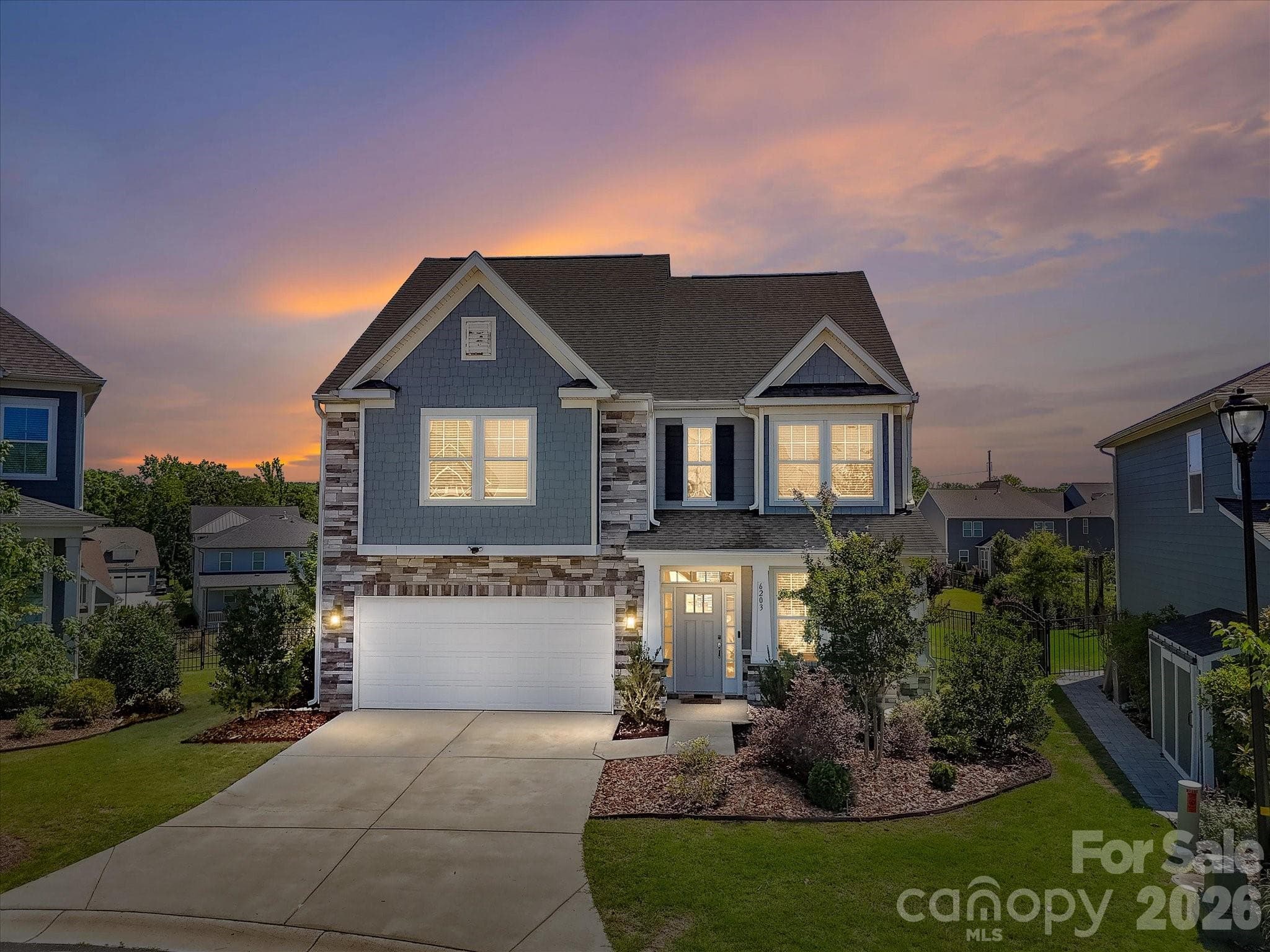 WELCOME TO YOUR NEW HOME AND LIFESTYLE! Twilight Drone View of Home - 6203 Six String Court, Fort Mill