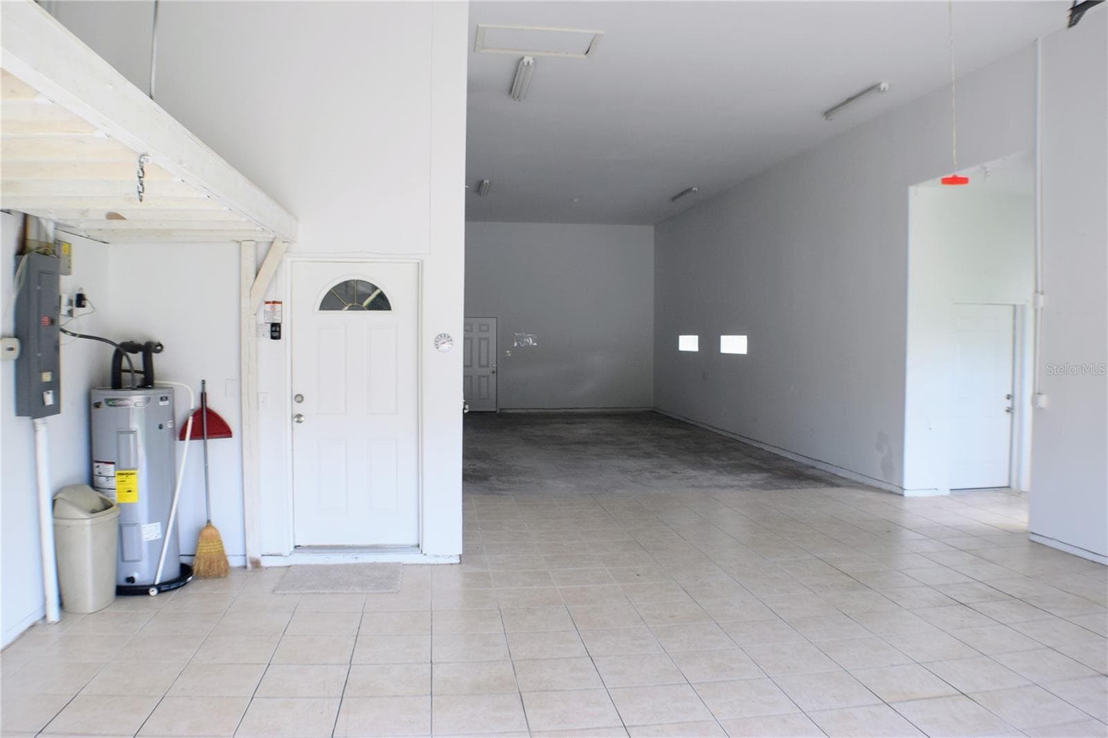 Large Garage with floored storage above. - 5941 MARVILLE CIR, PORT ORANGE