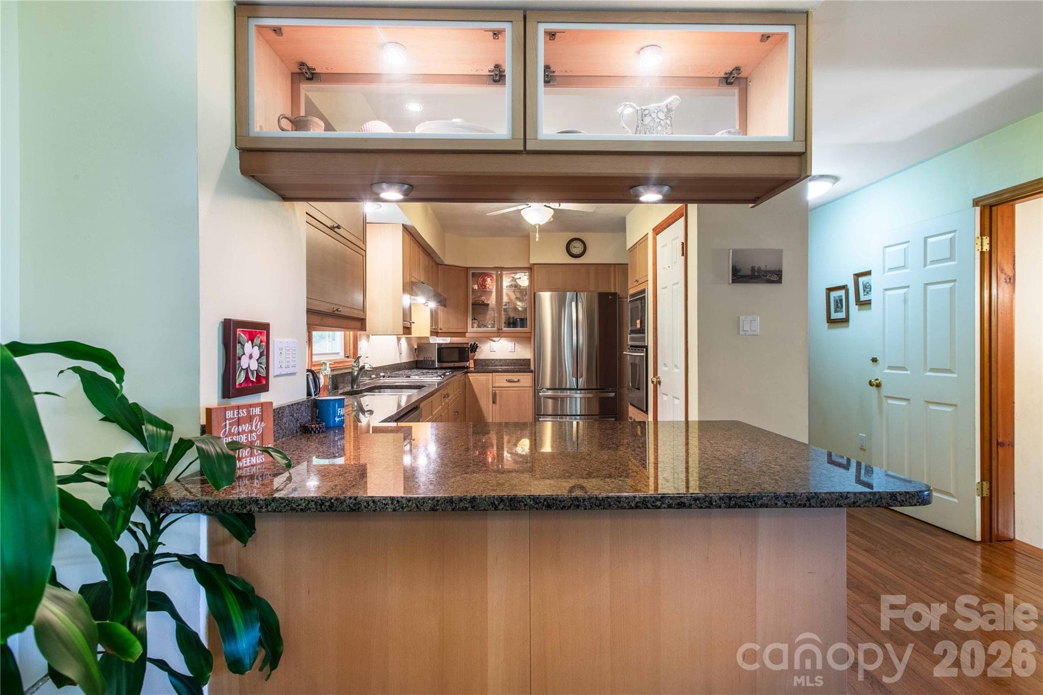 Eat-in kitchen allows guests to watch you create goumet or simple meals. Note the beautiful overhead lighted glass cabinets to display your favorite dishes, glassware, or bowls. - 22 Great Aspen Way, Black Mountain