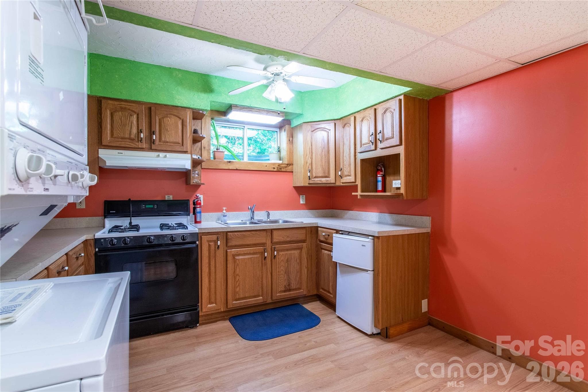 Lower level kitchenette features never used stacked washer and dryer. There is also space for a snack bar on the right. - 22 Great Aspen Way, Black Mountain