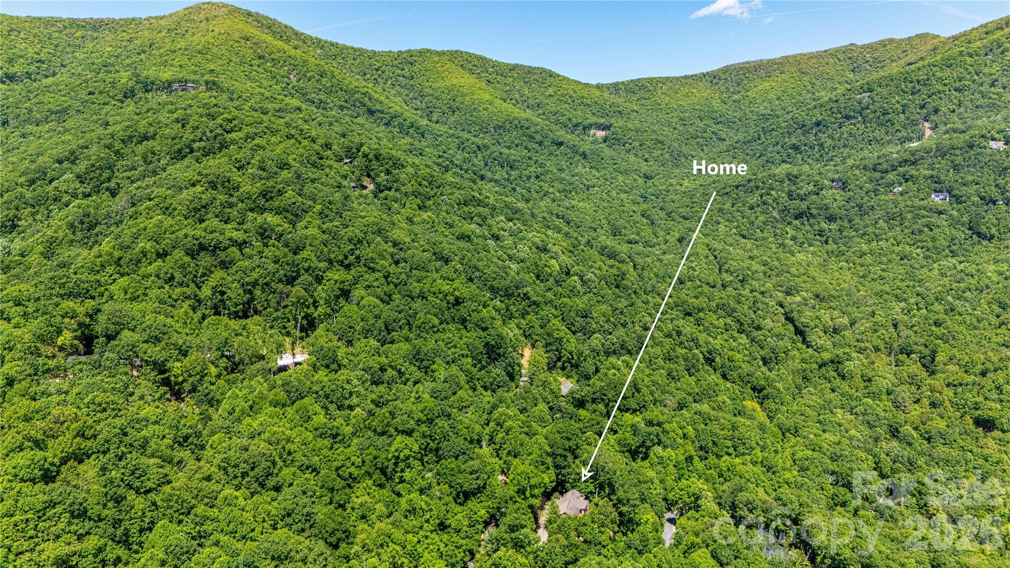 An overhead drone shot that shows the house's location. Note how the area is still very much in a natural state. Living in Laurel Ridge is like living off the Blue Ridge Parkway, but only minutes to downtown Black Mountain and I-40. - 22 Great Aspen Way, Black Mountain