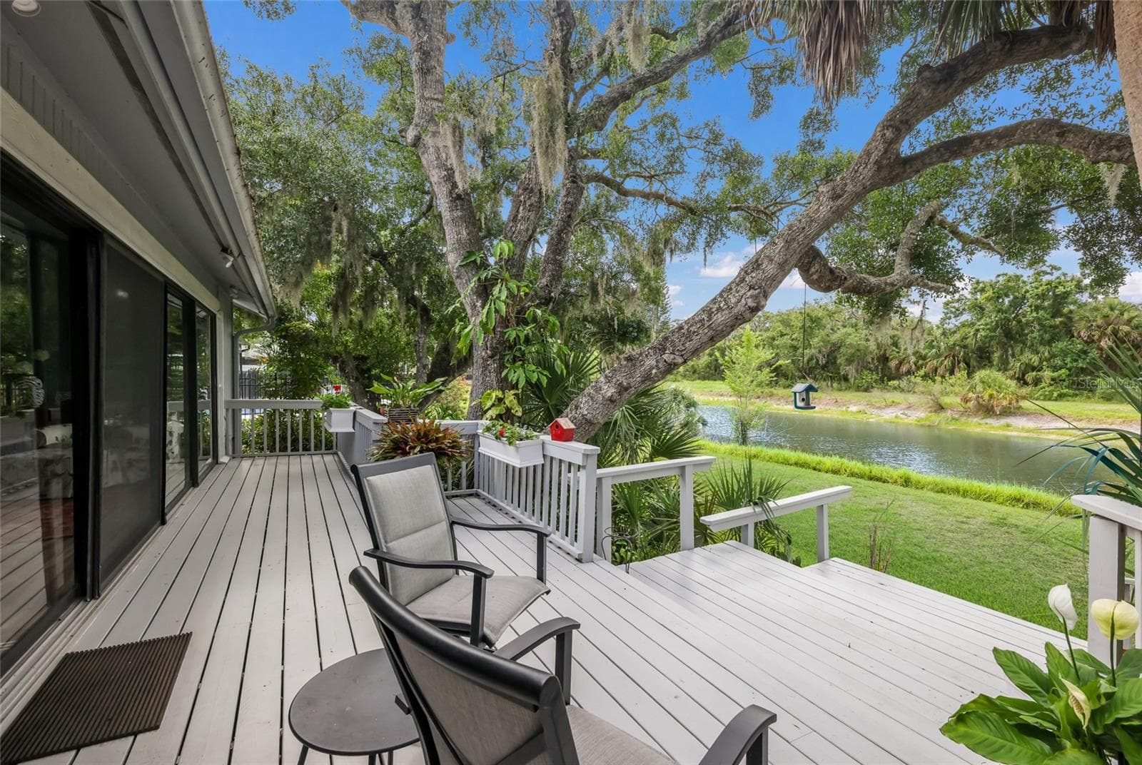 Newer 30-ft. deck, the perfect place for morning coffee, outdoor dining, or simply relaxing. - 851 FAULKWOOD CT, SARASOTA