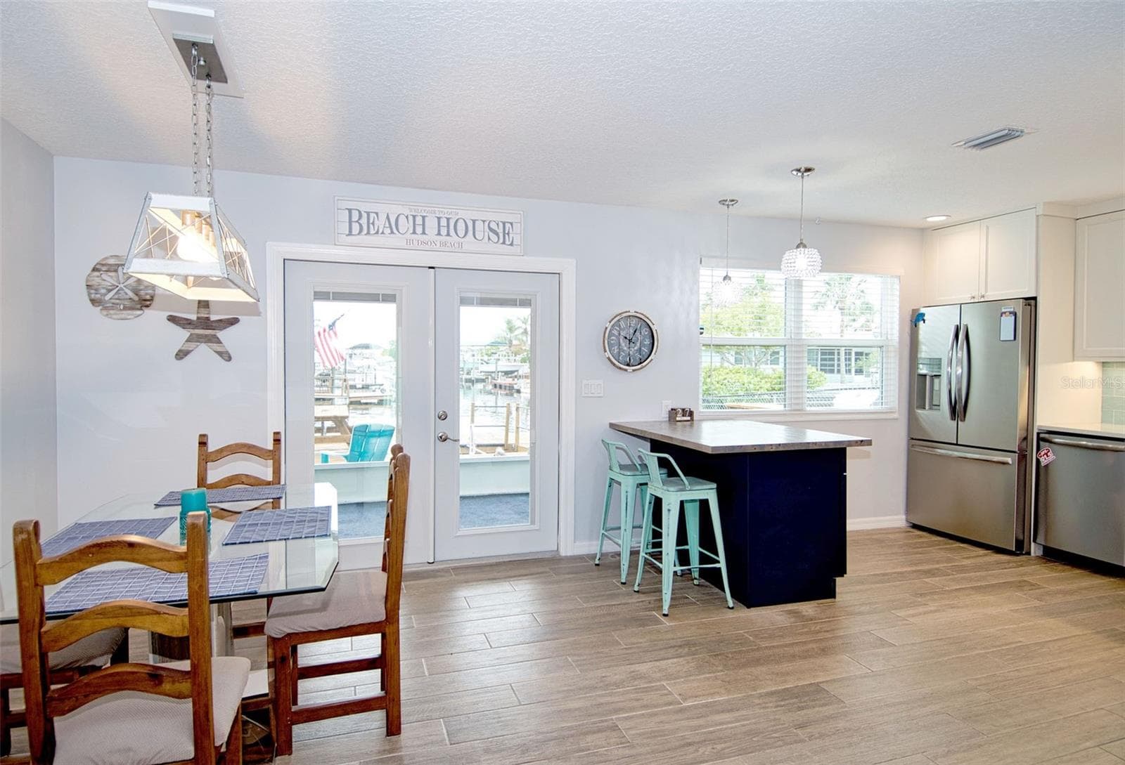 Attention to detail is evident with this easy care flooring throughout, neutral paint, striking kitchen offers dual color cabinetry featuring dark blue lowers with white uppers and coordinating back splash for that WOW factor!! - 6420 BOATYARD DR, HUDSON