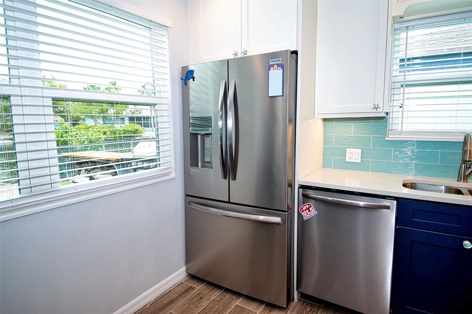 Large windows bring the outside in with view of canal and boats motoring out to Gulf waters. - 6420 BOATYARD DR, HUDSON