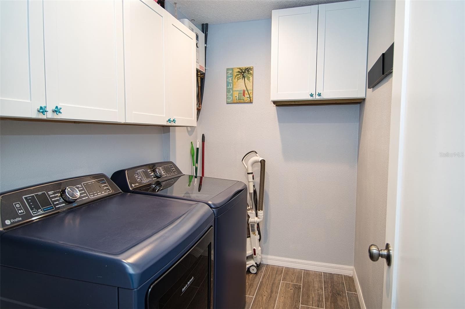 Spacious inside laundry utility room. Plenty of overhead cabinet storage space for cleaning supplies. - 6420 BOATYARD DR, HUDSON