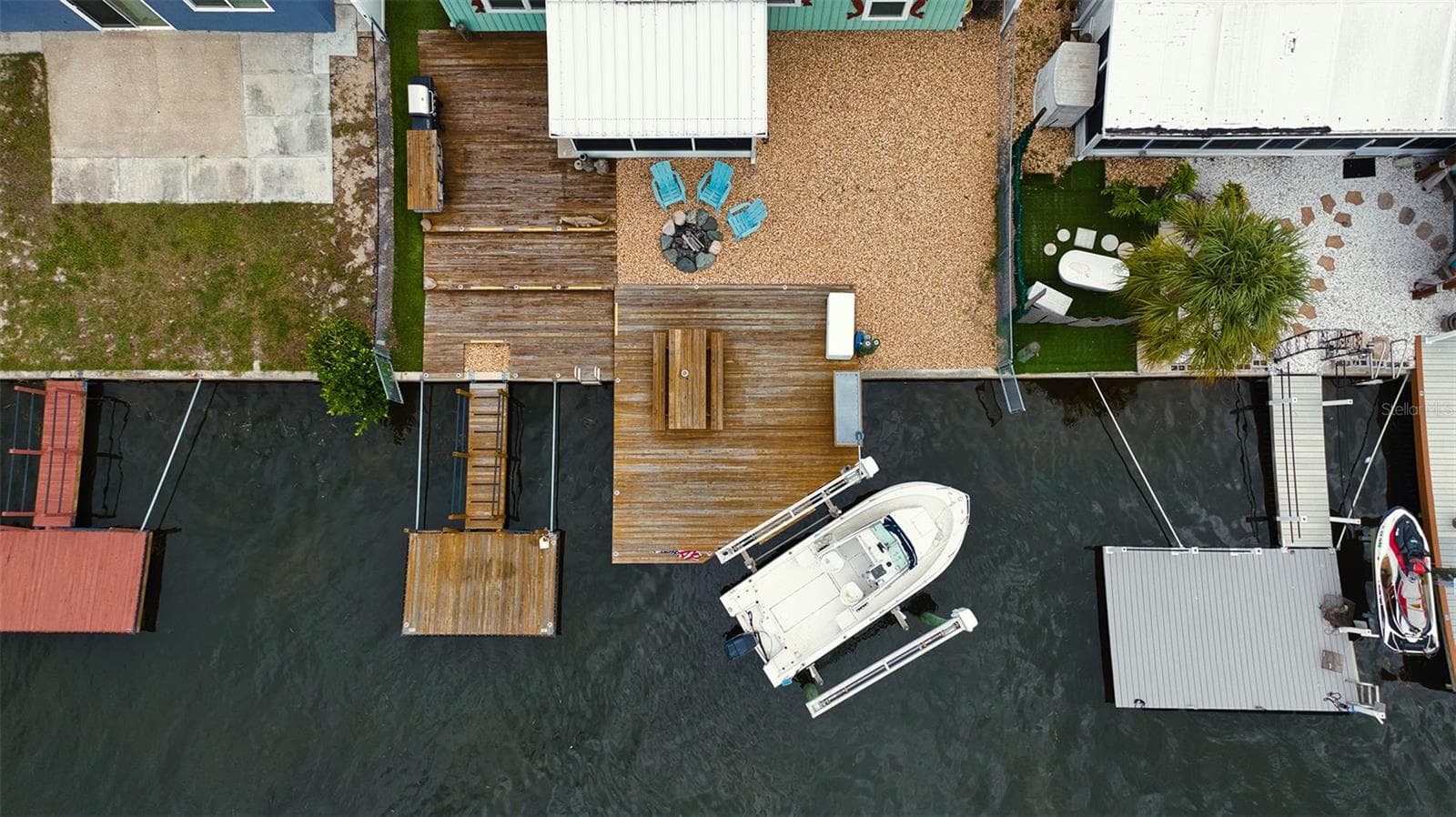 Overview of this easy care backyard space, docks and boat lift. - 6420 BOATYARD DR, HUDSON