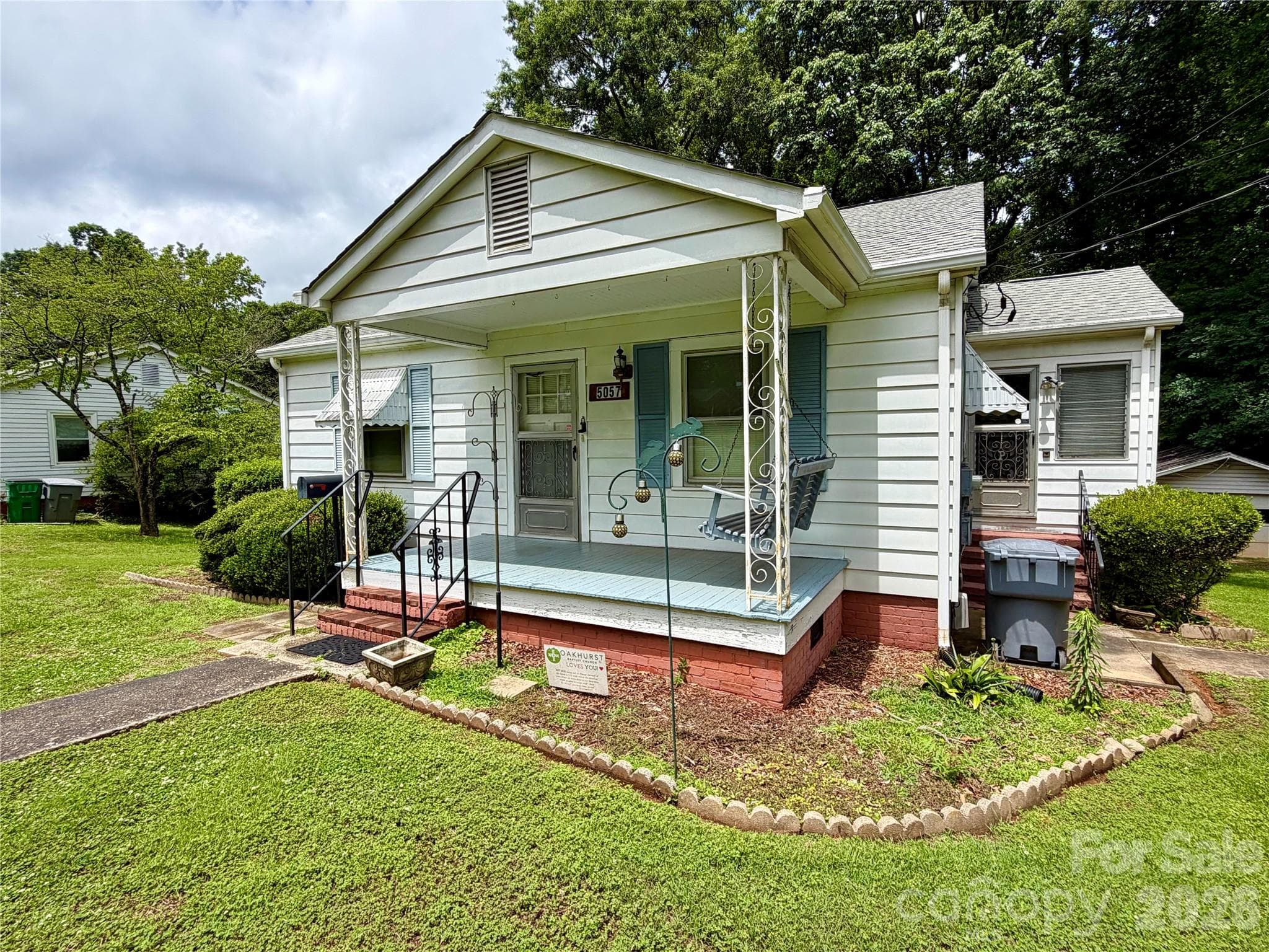 Side of home where there is an exterior entrance to both main floor and the basement from the porch. - Charlotte