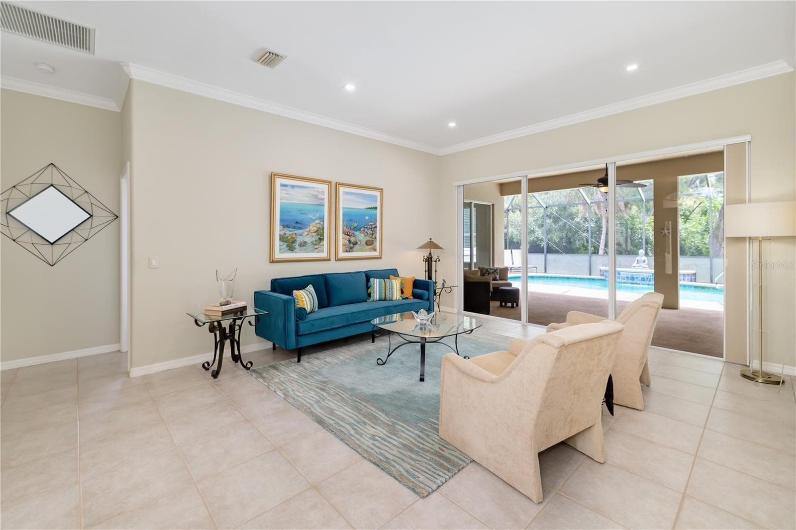 Florida room, living room, with ceramic tile flooring easy to bring the outdoors inside with views of the gorgeous pool, glass sliders - 12471 NATUREVIEW CIR, BRADENTON