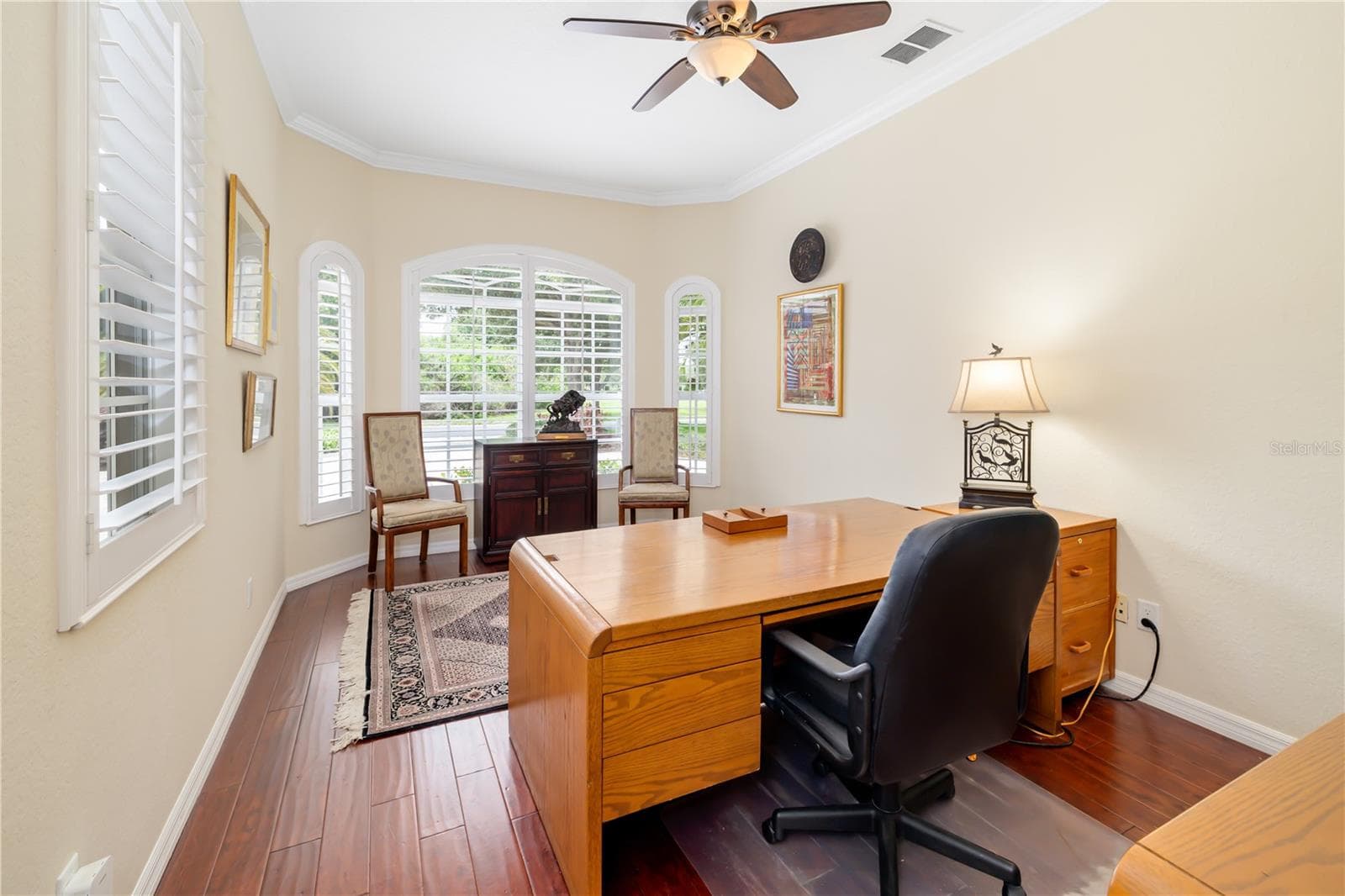 Den, office, on the first floor, next to the 1/2 bath, plantation shutter windows, engineered hardwood flooring, for the executive or work from home lifestyle. - 12471 NATUREVIEW CIR, BRADENTON