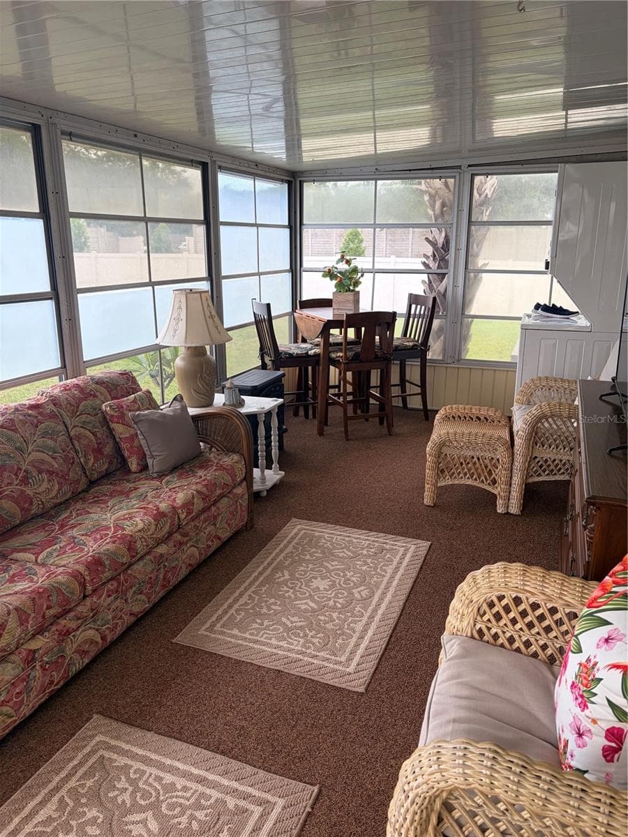 Side porch has an abundance of windows for natural light. - 723 ROMA RD, VENICE