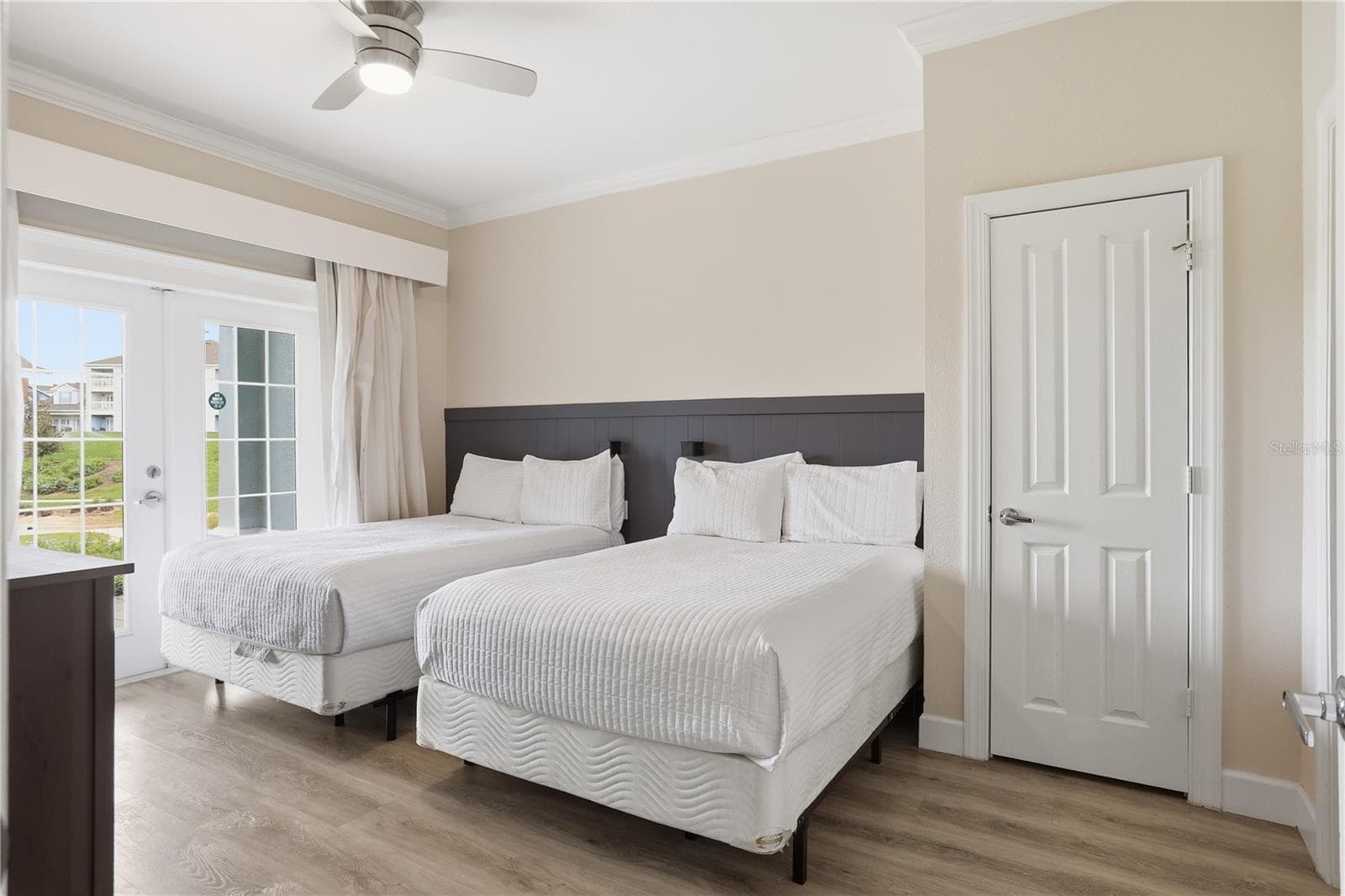 Spacious primary bedroom with its own private balcony overlooking the golf course. - 7673 HERITAGE CROSSING WAY #102, REUNION