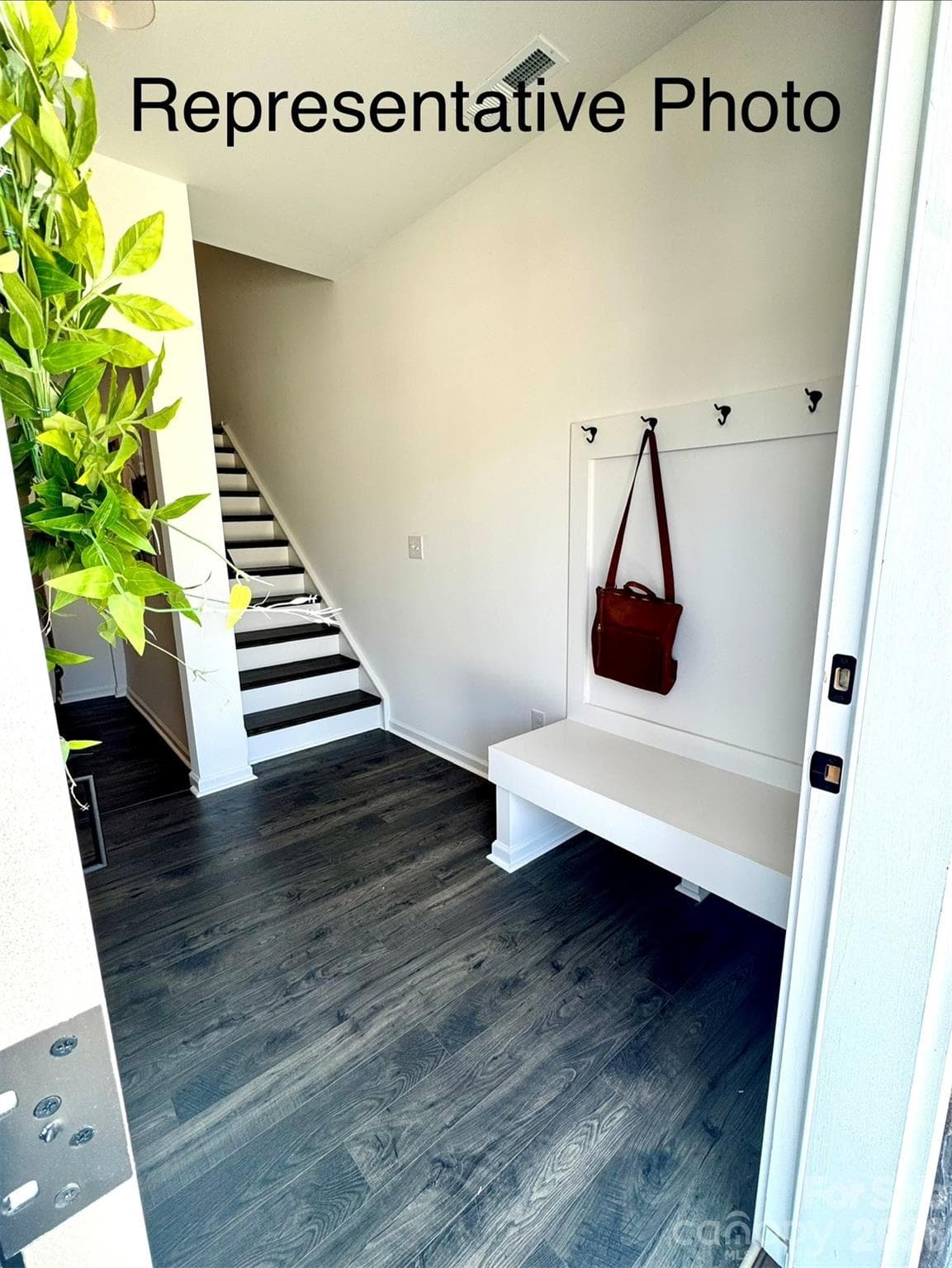Foyer features included drop zone and hardwood staircase to 2nd floor - Clover