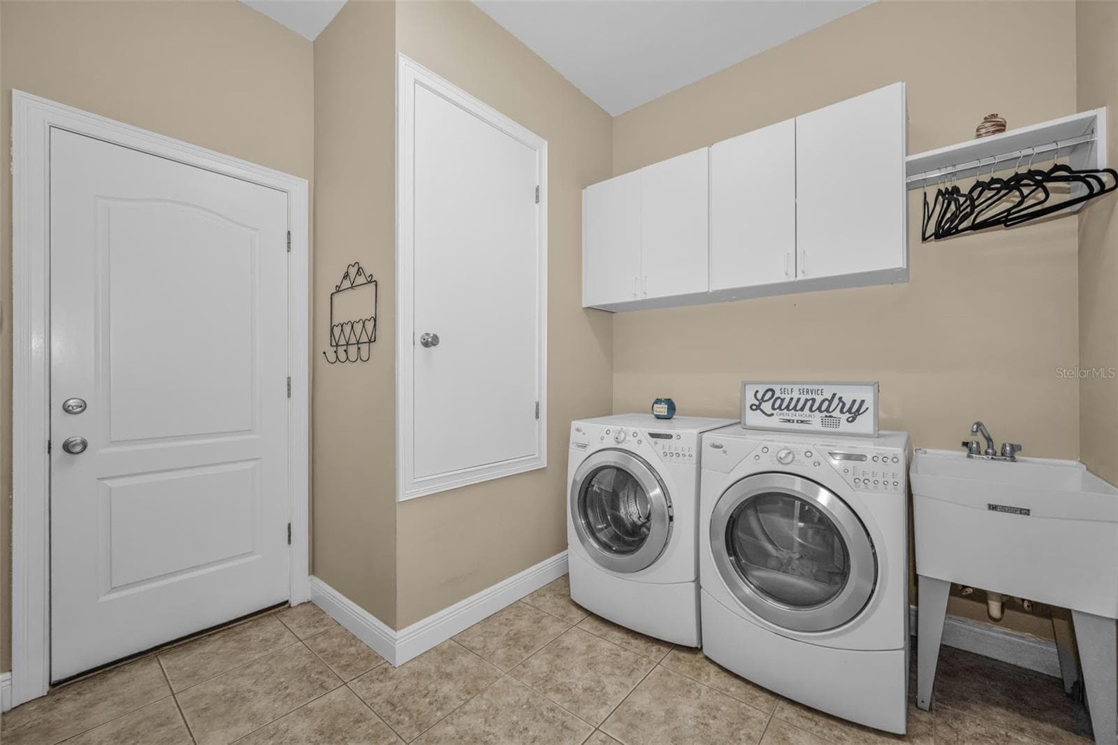 Indoor Laundry Room with Mud Sink and Cabinets - 1888 BUGLE LN, CLEARWATER