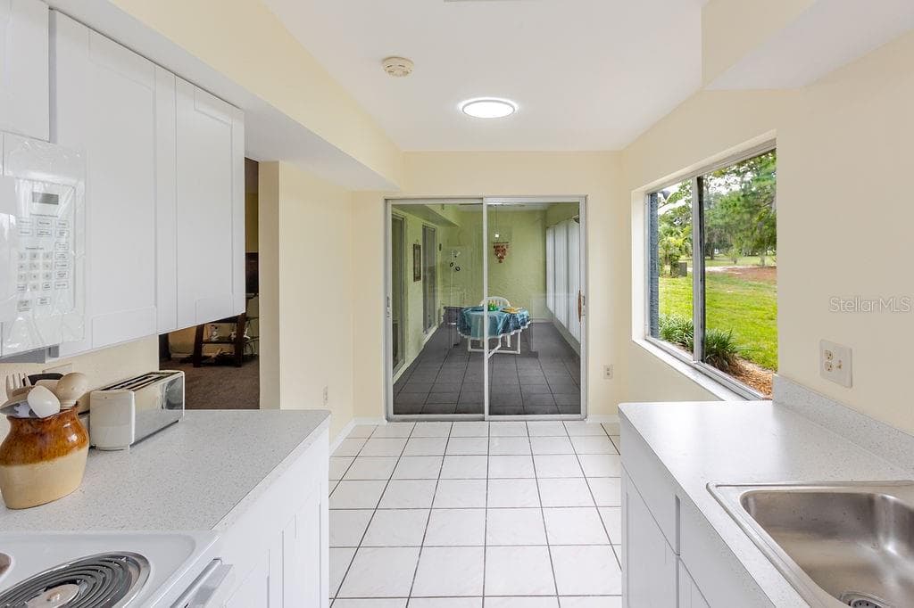 Kitchen to sunroom - 7560 ST ANDREWS BLVD #7560, WEEKI WACHEE