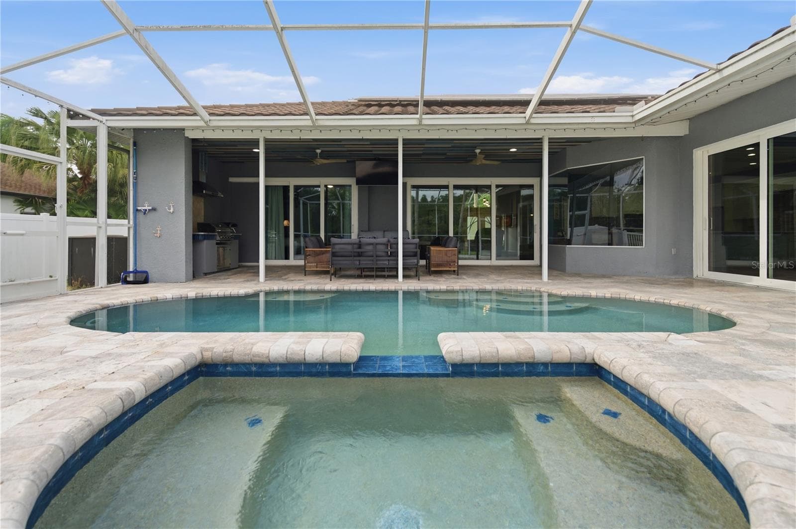 View from the Spa of the Covered Pool Patio and Outdoor Kitchen - 17024 WINNERS CIR, ODESSA