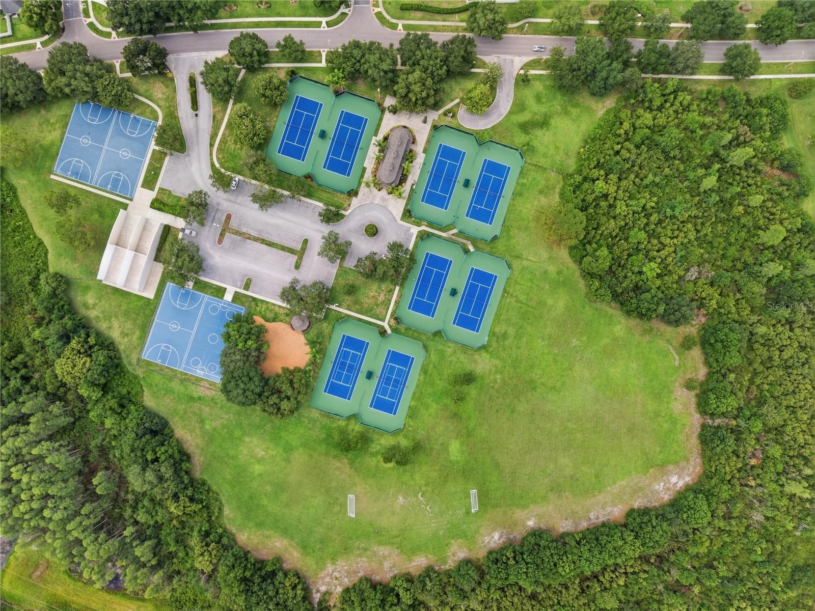 Aerial view of the Van Dyke Farms amenities around the Clubhouse. Tennis, Racquetball, Basketball, Hockey, Soccer & a Baseball Diamond. - 17024 WINNERS CIR, ODESSA