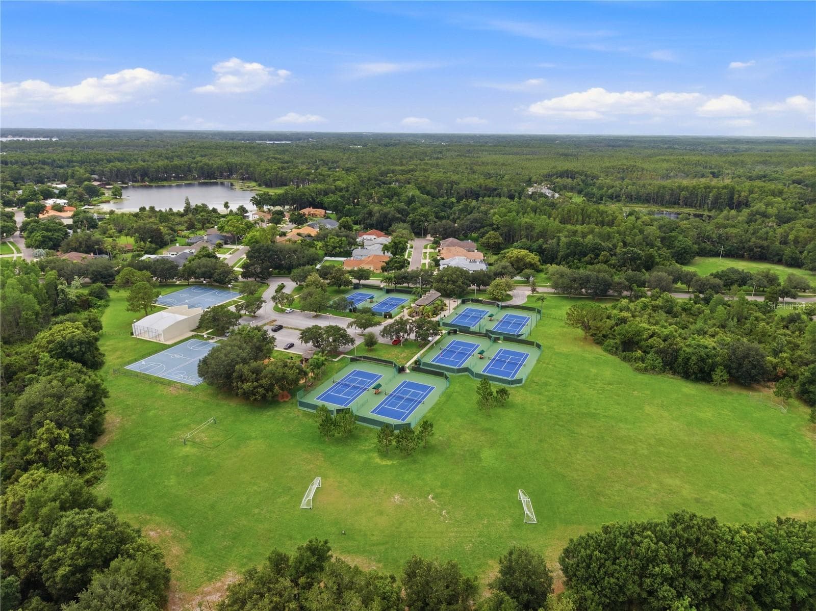 Aerial view of the Van Dyke Farms amenities around the Clubhouse. Tennis, Racquetball, Basketball, Hockey, Soccer & a Baseball Diamond. - 17024 WINNERS CIR, ODESSA
