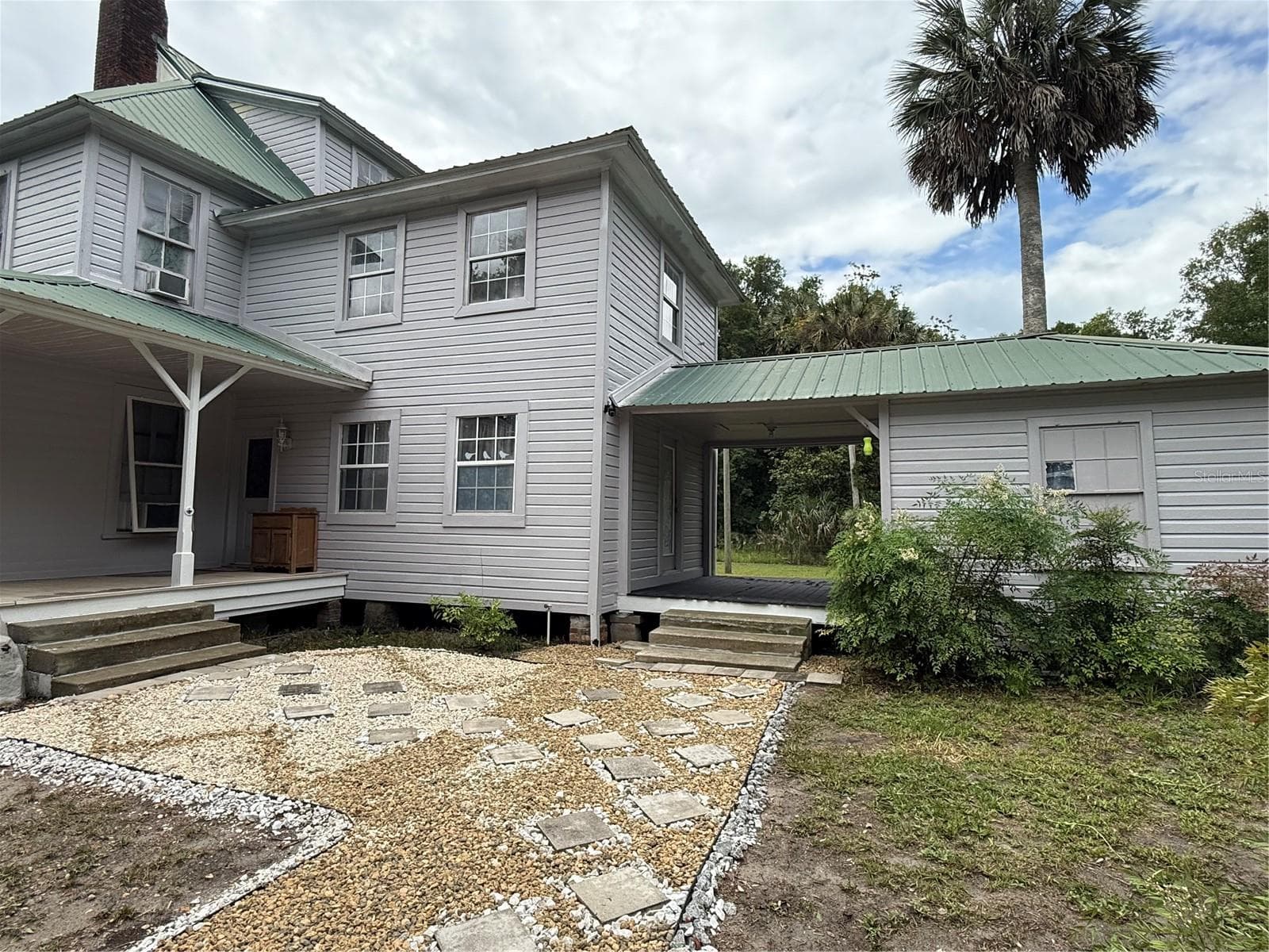 Back of the house with Laundry attached - 110 N VOLUSIA AVE, PIERSON