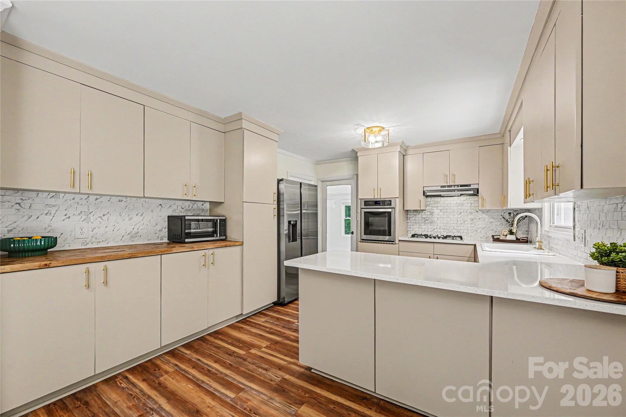 Dedicated butcher block workspace and extensive pantry style storage keep everything within reach. - Concord