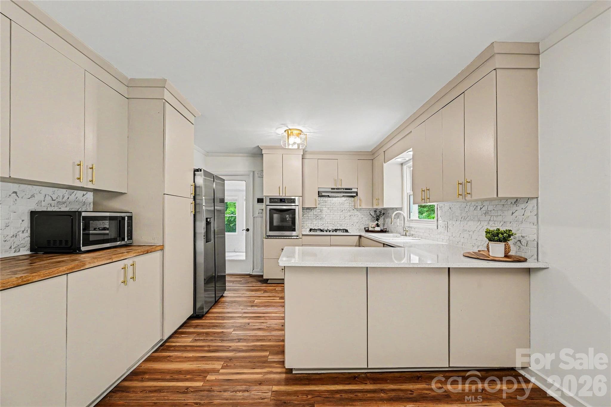 Spacious kitchen with oversized peninsula seating, extensive cabinet storage, and newer appliances. - Concord