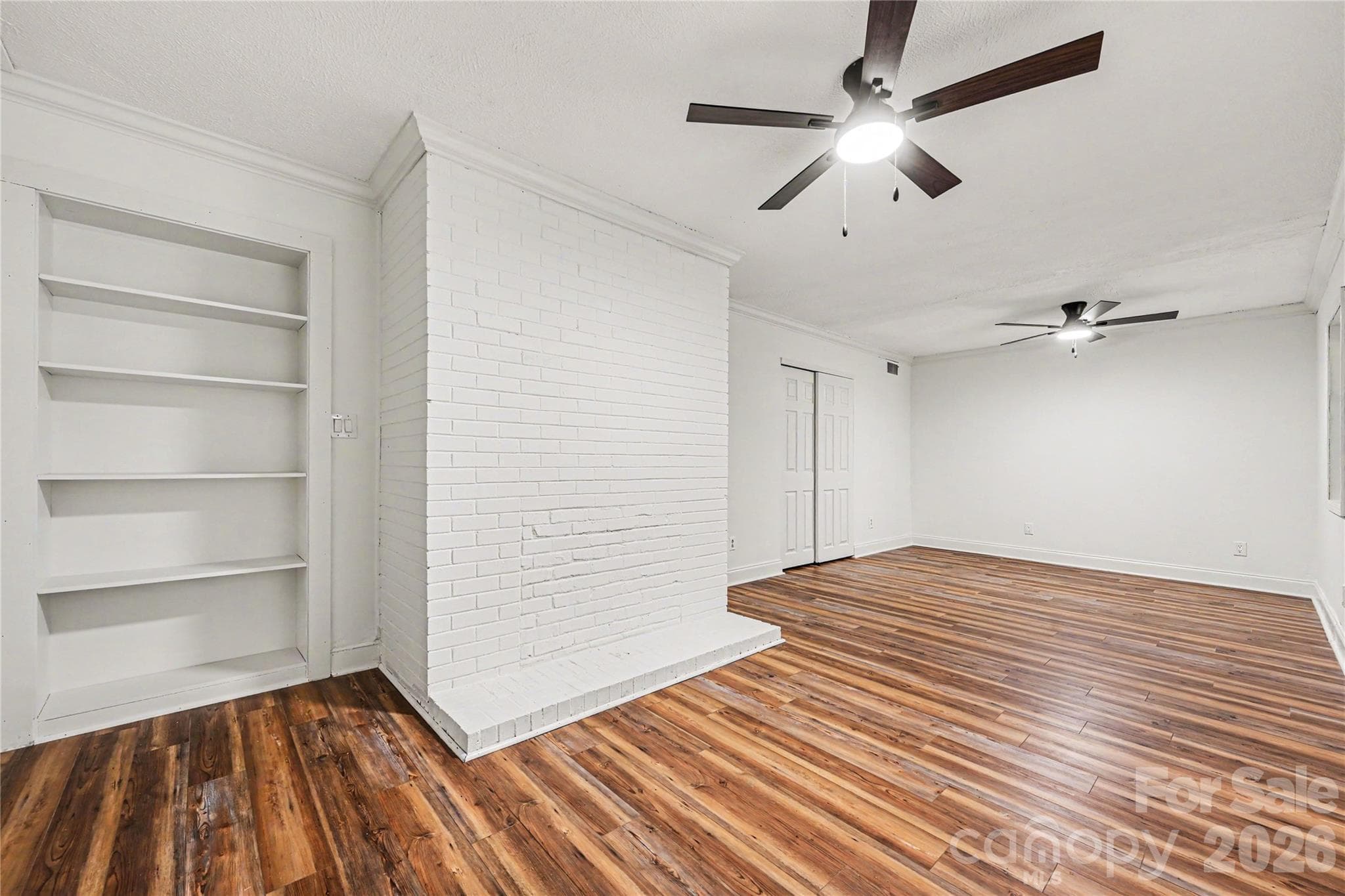 Spacious lower level flex room featuring a closet, built in shelving, and endless possibilities for a home office, recreation room, media space, or guest retreat. - Concord