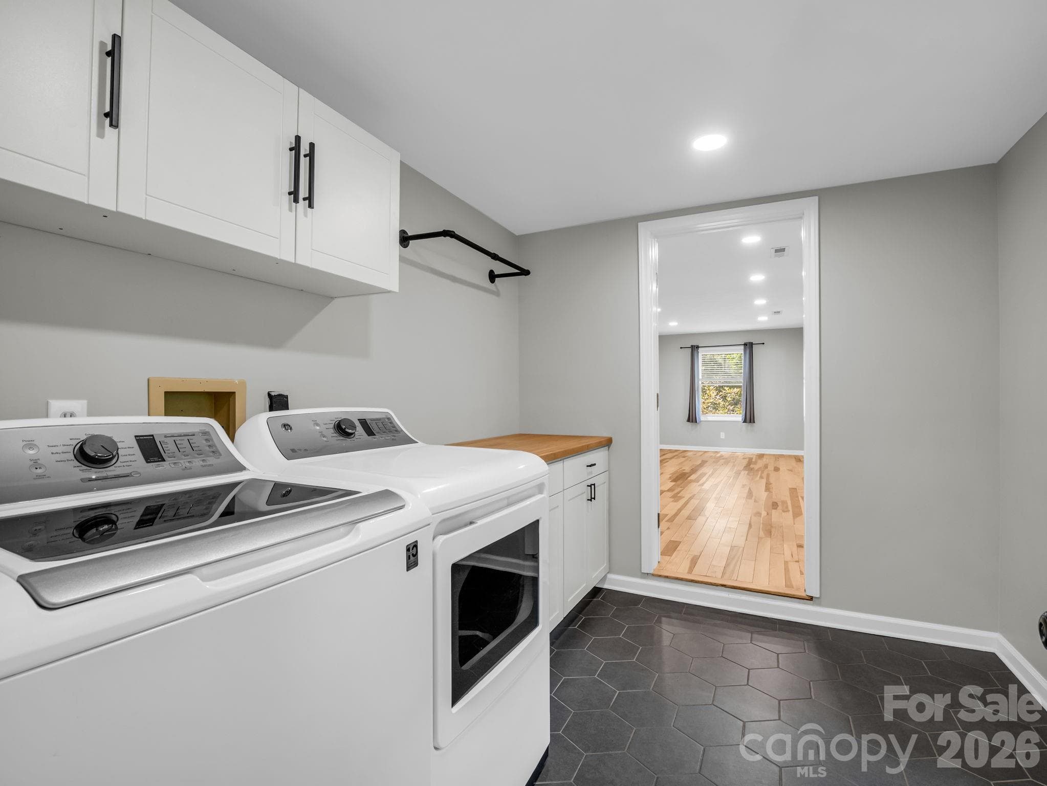 Laundry Room with tiled floor, opens to Primary Bedroom - 35 Chastain Hill Road, Mills River