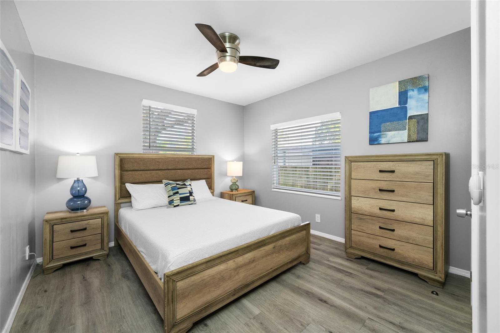 Primary Bedroom suite with walk-in closet, with built in shevles, that opens through to private en-suite updated bathroom with marble tile and glass shower. - 5044 BETTY ST N, ST PETERSBURG
