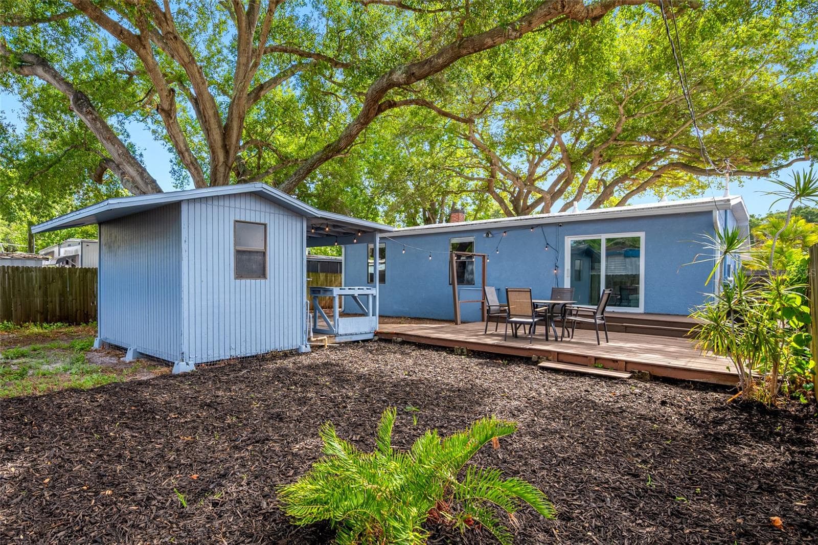 Fenced in back yard with 20ft wide deck that leads to detached workshop and shed. - 5044 BETTY ST N, ST PETERSBURG
