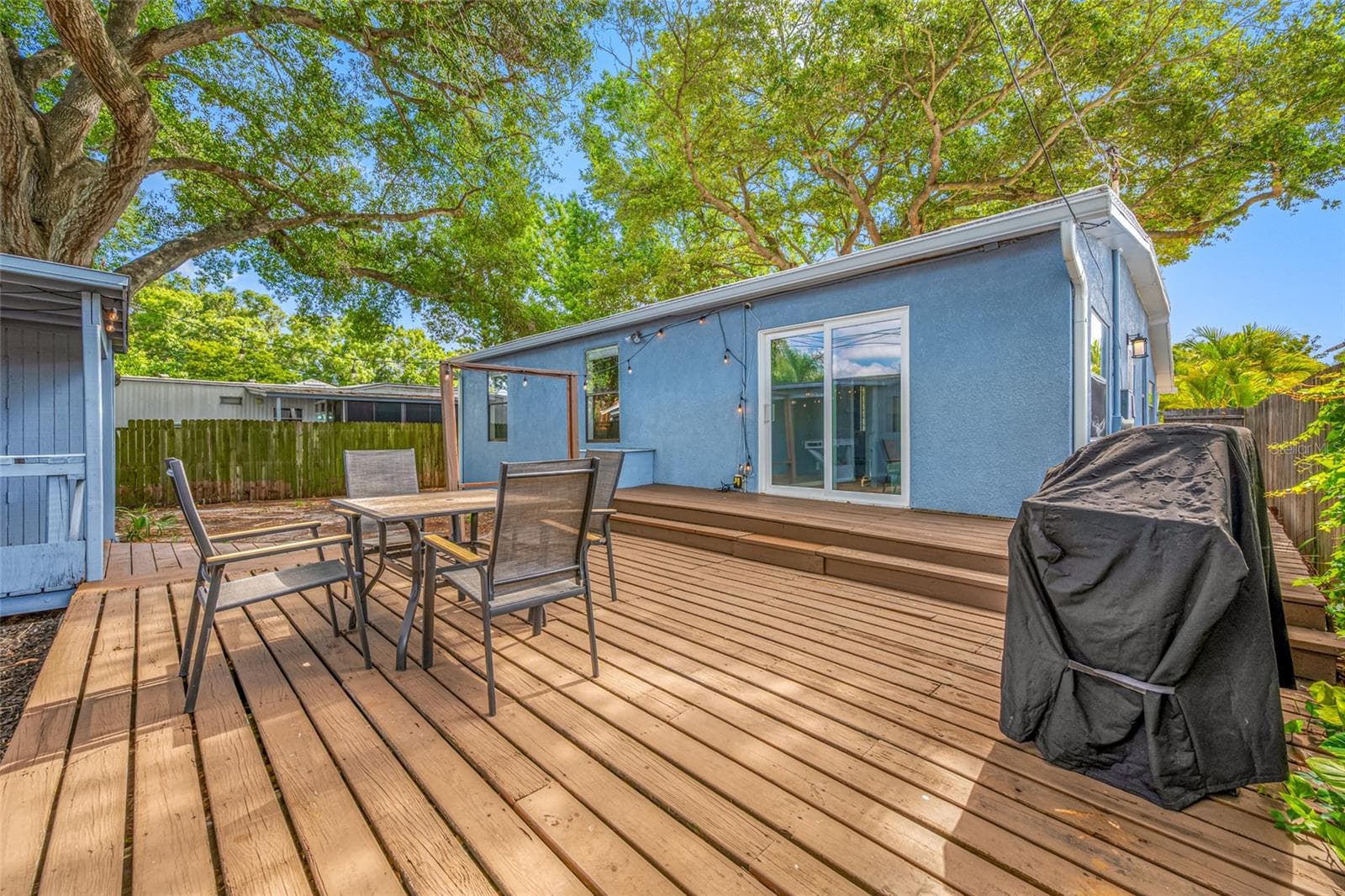 Fenced in back yard with 20ft wide deck that leads to detached workshop and shed. - 5044 BETTY ST N, ST PETERSBURG